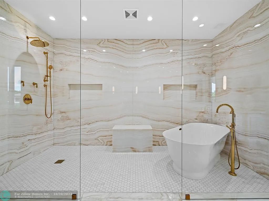 A bathroom with a bathtub and a walk in shower.