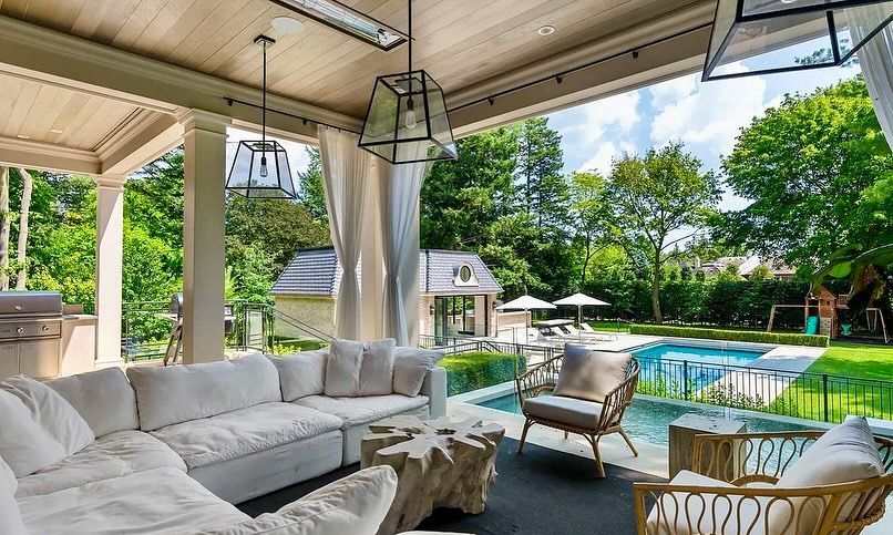 A living room with a couch , chairs , and a pool.