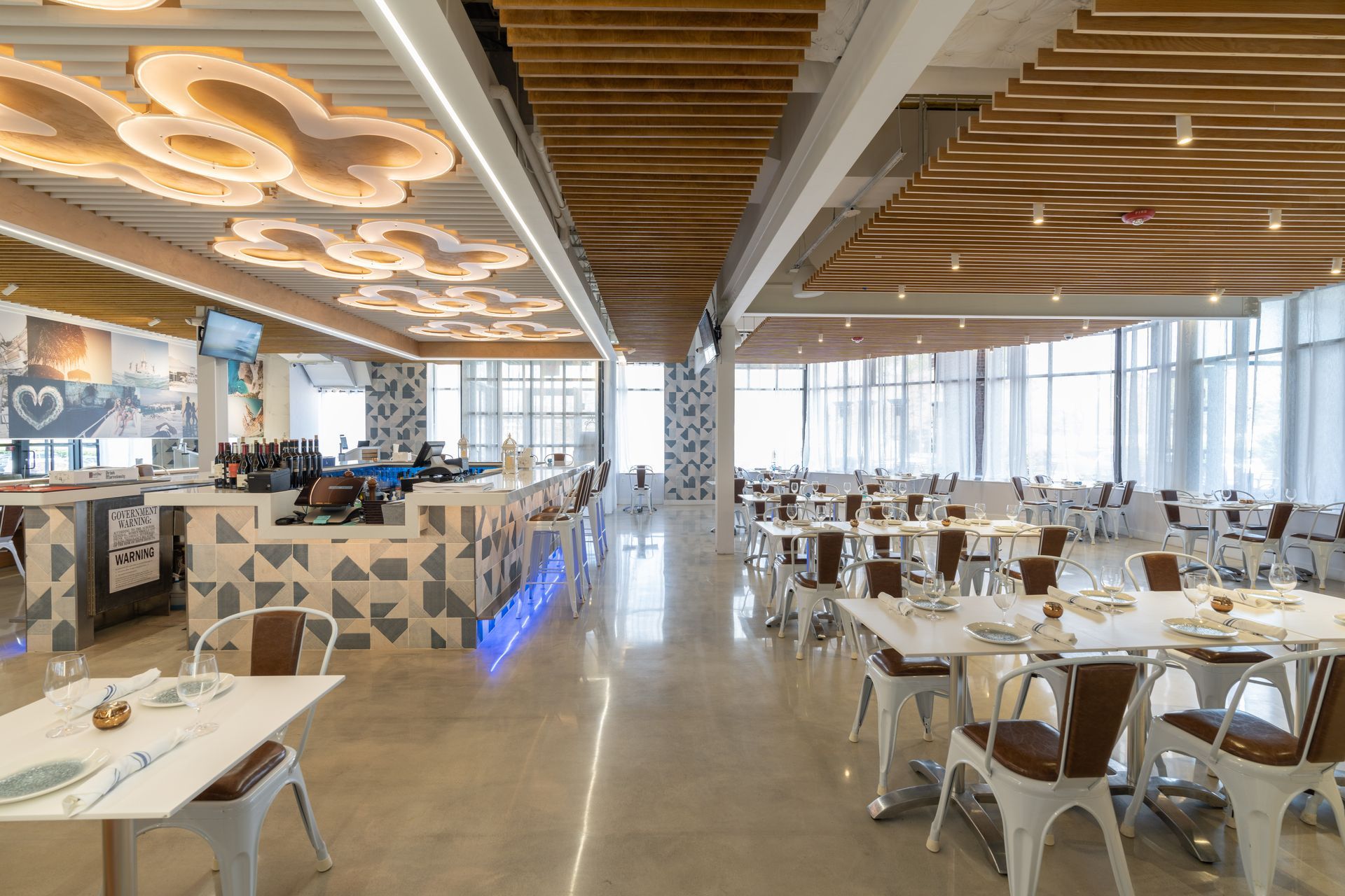 A large dining room with tables and chairs in a restaurant.
