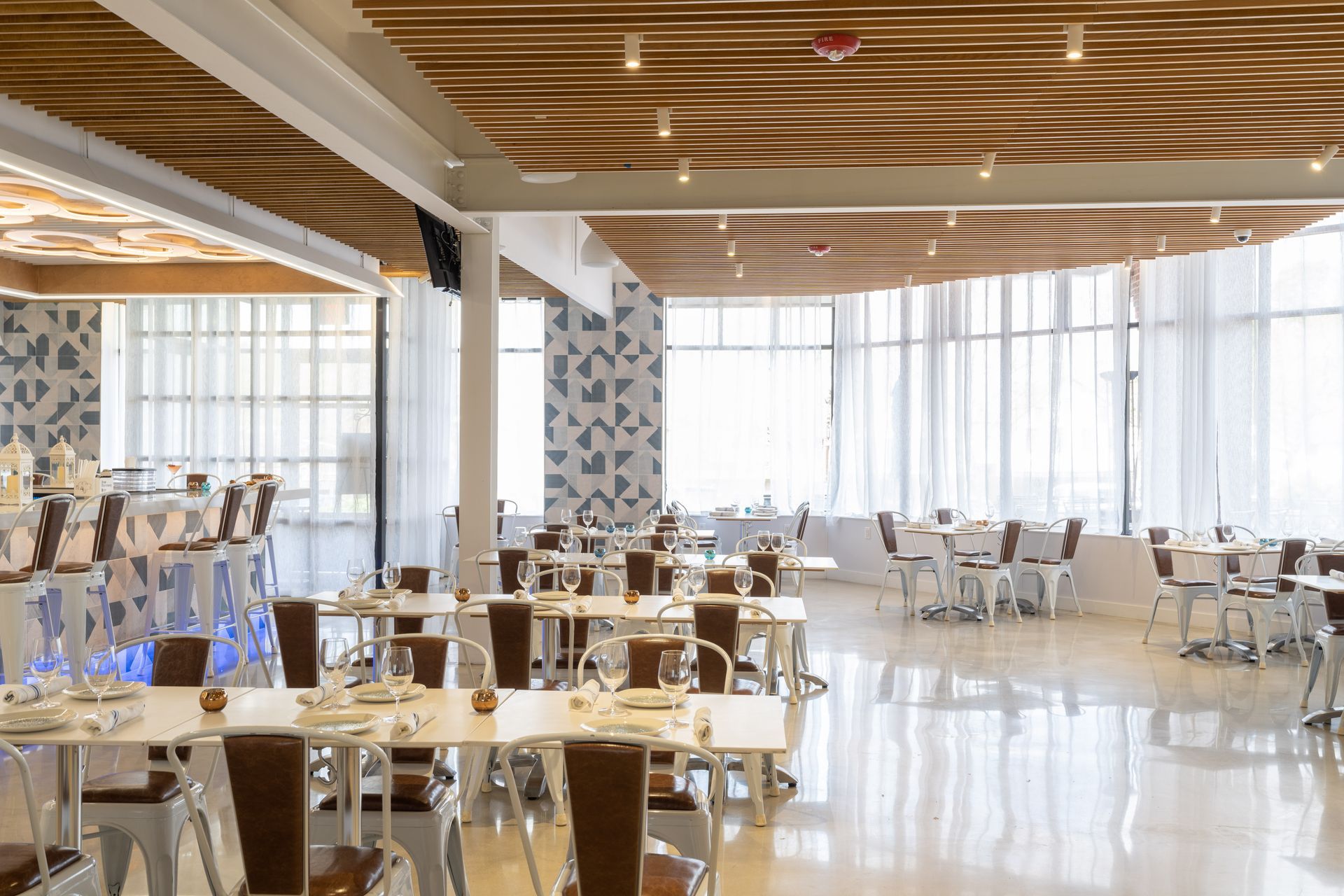 A large dining room with tables and chairs in a restaurant.