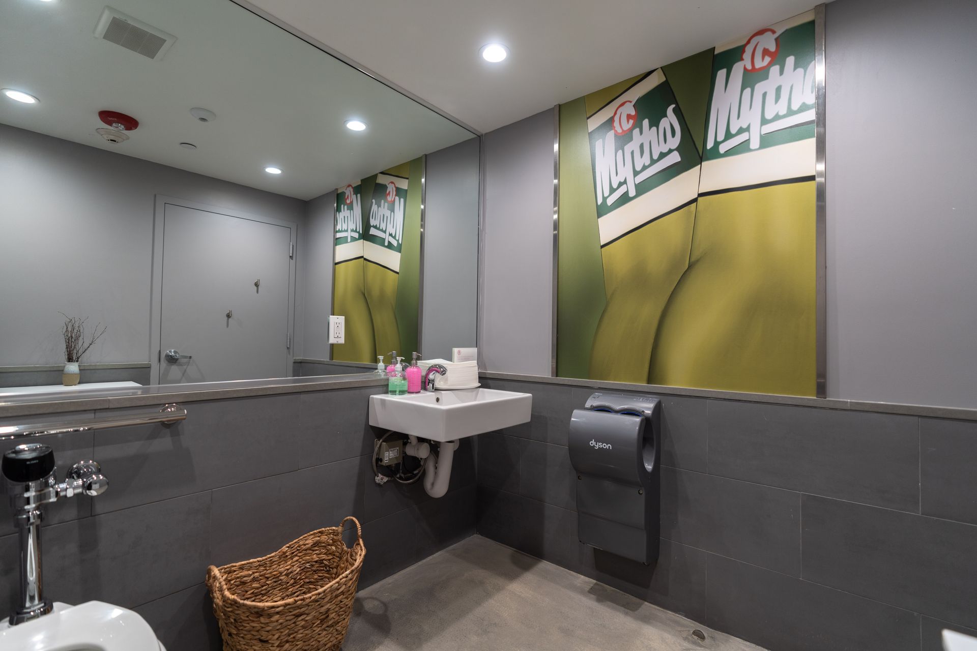 A bathroom with a sink , toilet , and mirror.