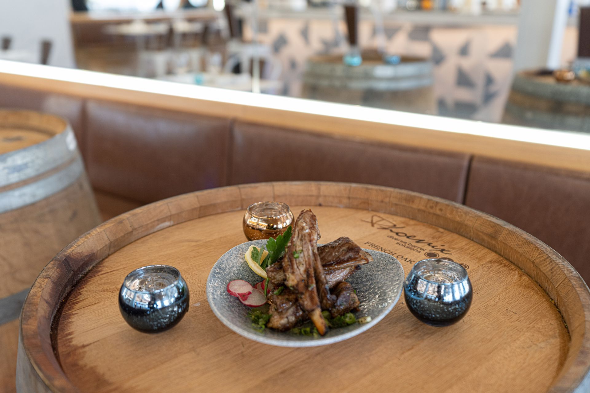 A plate of food is sitting on top of a wooden barrel.