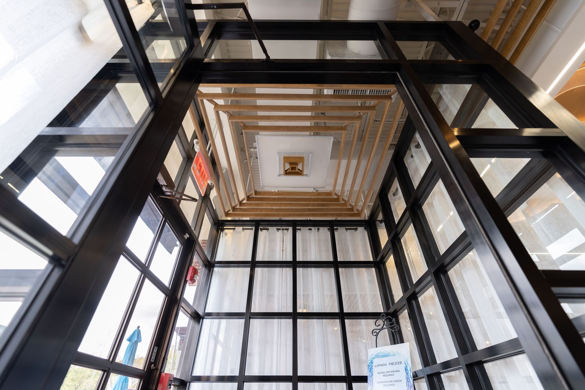 Looking up at the ceiling of an elevator in a building