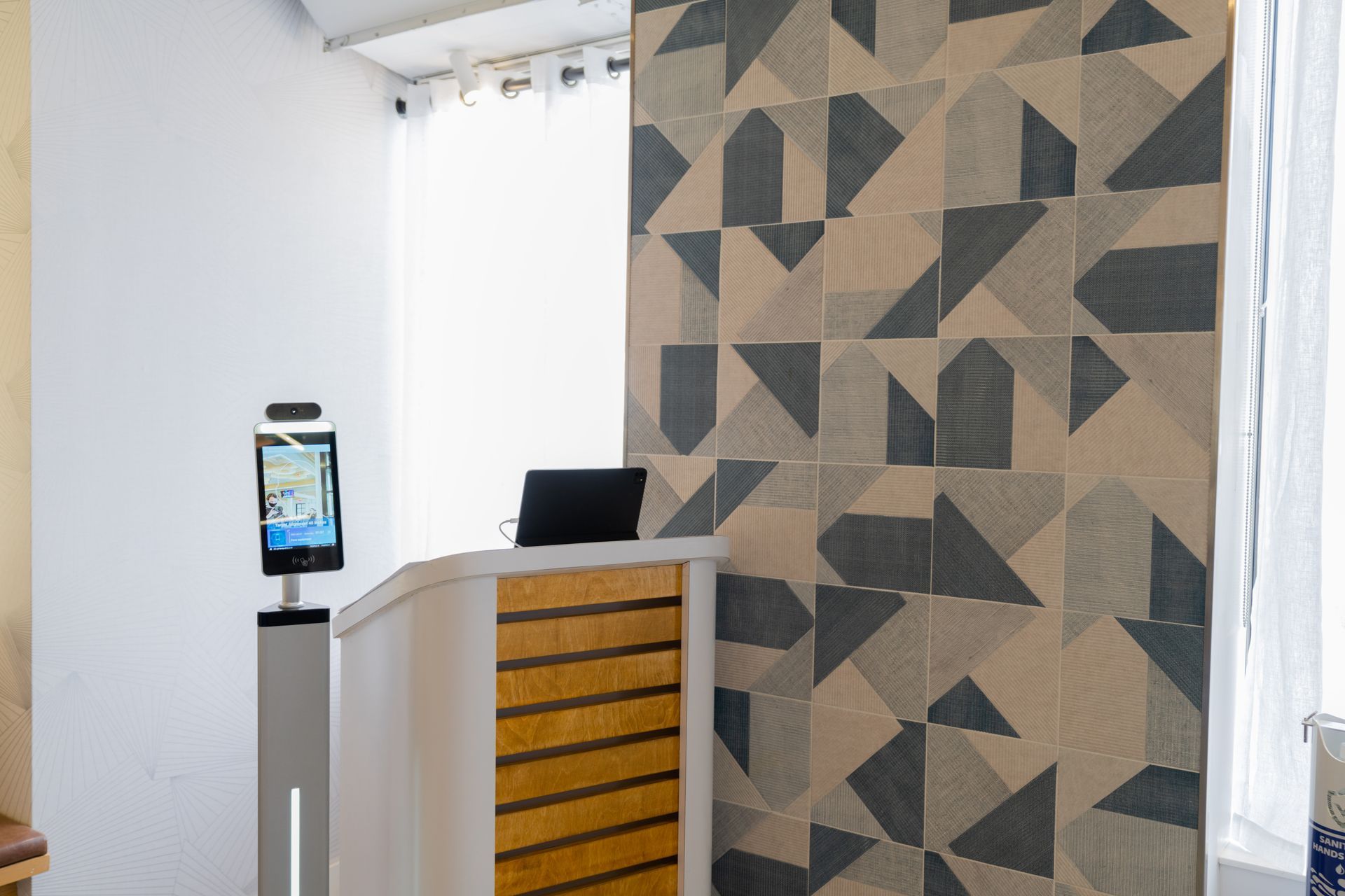 A room with a podium and a wall with a geometric pattern.
