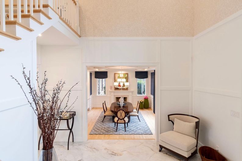 A living room with a dining room table and chairs