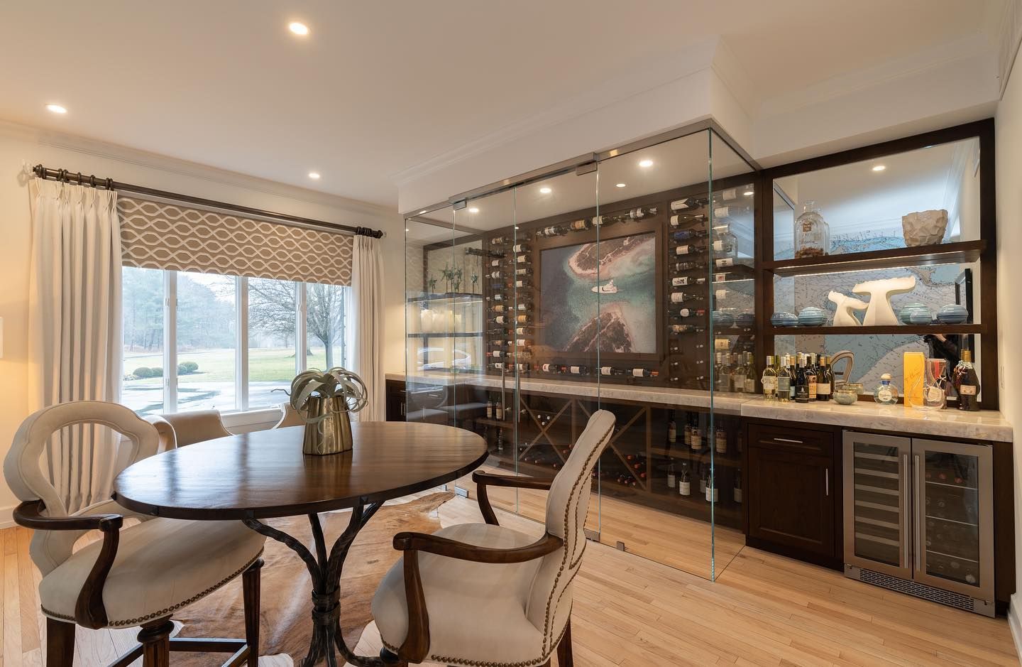 A dining room with a table and chairs and a bar.