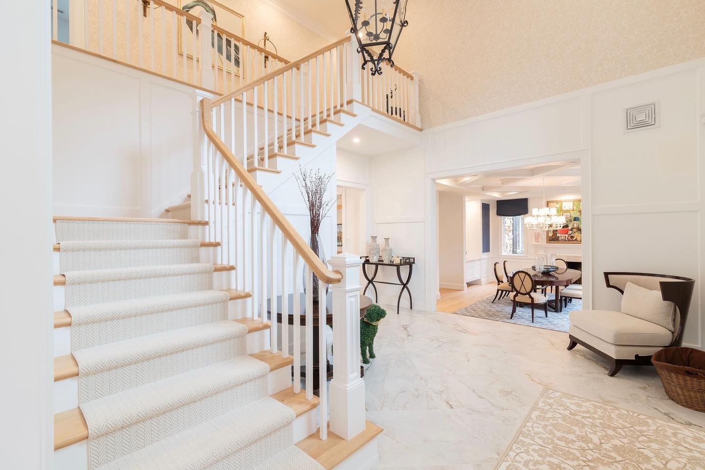 There is a staircase in the middle of the room leading up to the second floor.