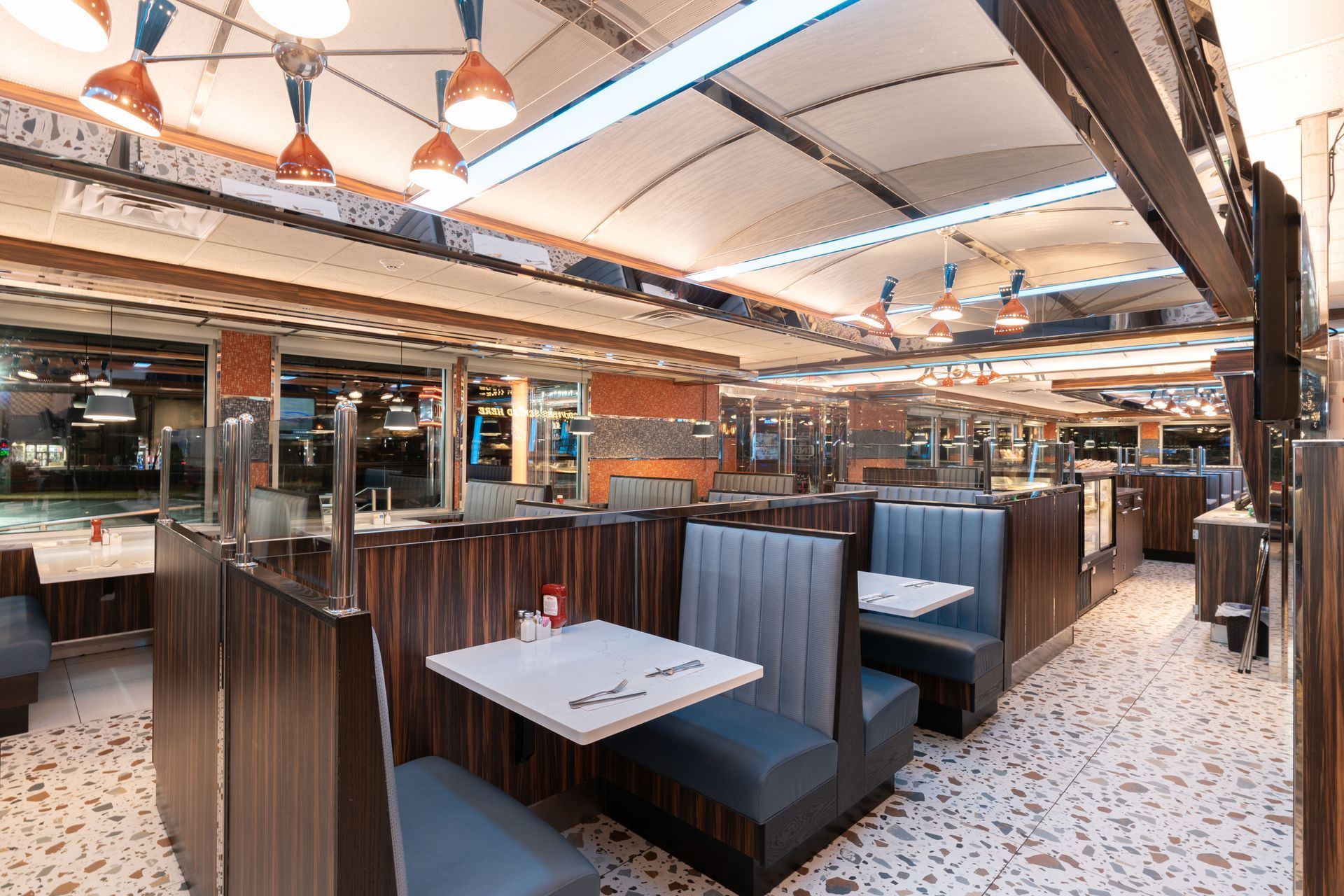 A diner with tables and benches in it.