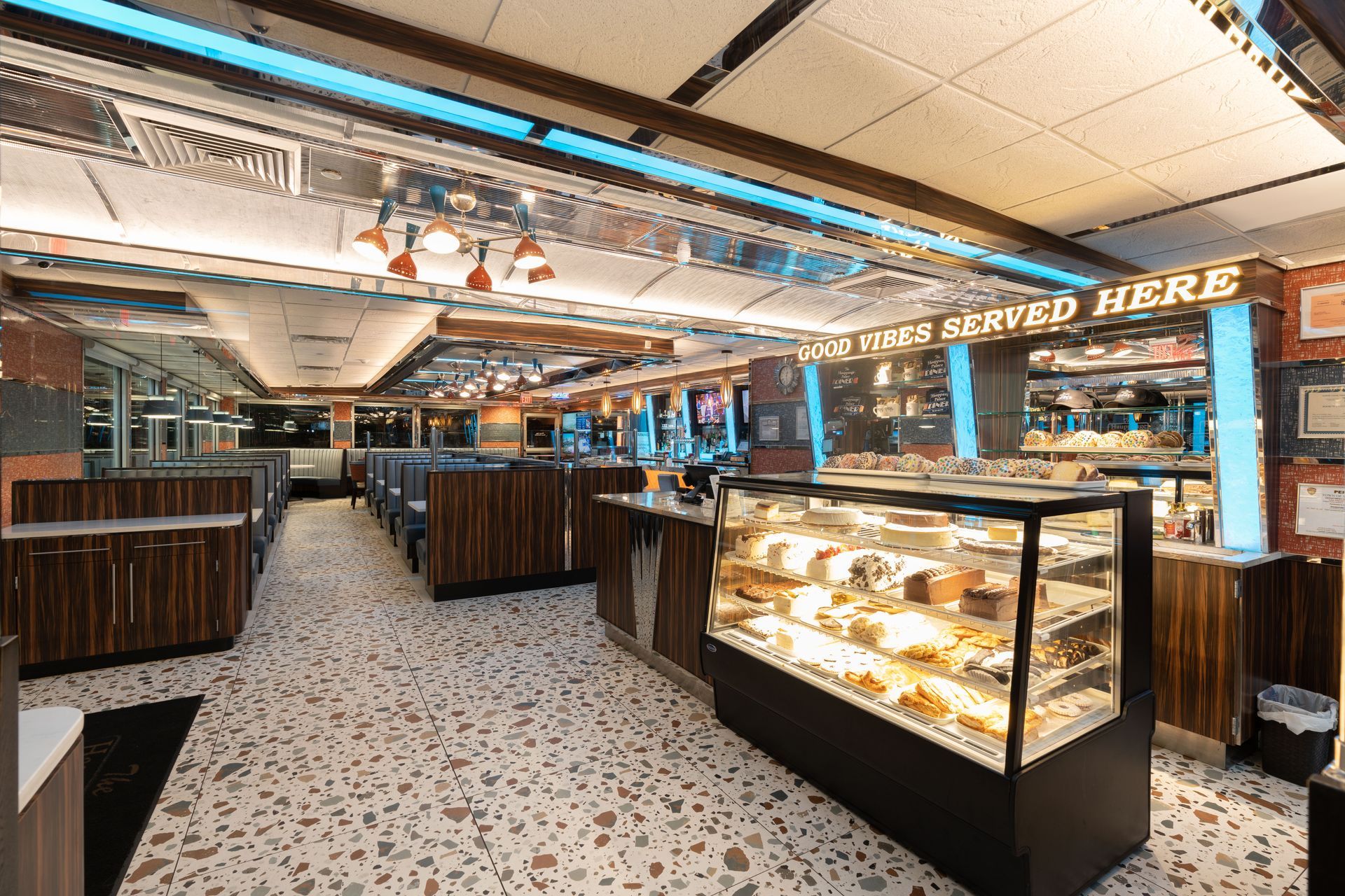 A diner with a display case filled with food and a sign that says `` served here ''.
