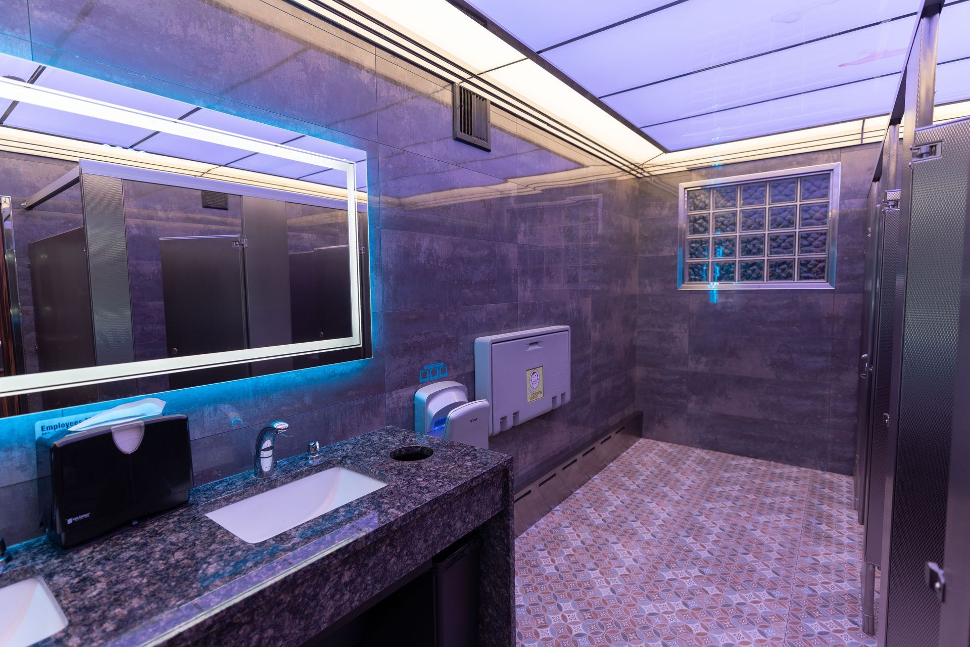 A bathroom with a sink , mirror , and toilet.