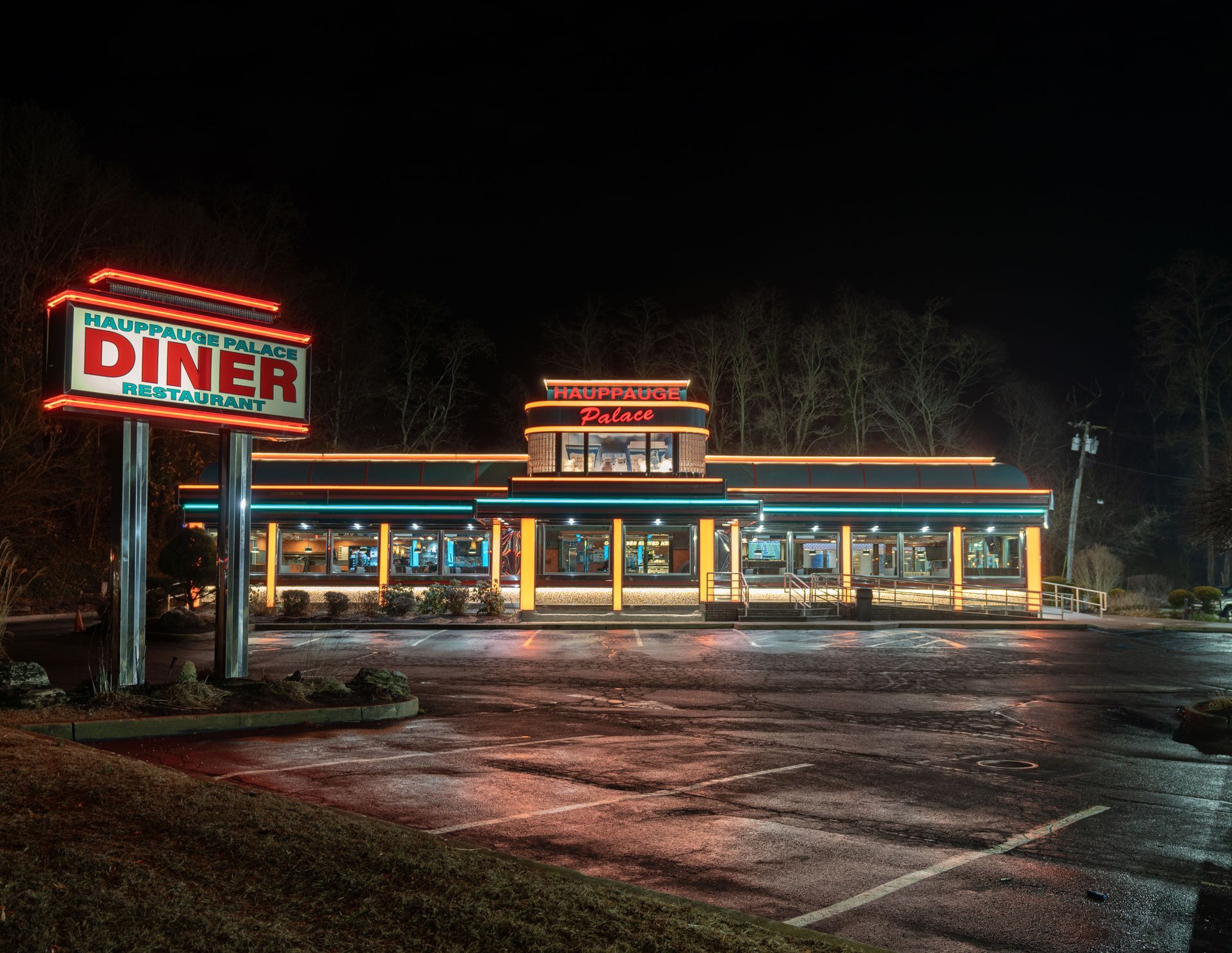 A diner is lit up at night with a neon sign
