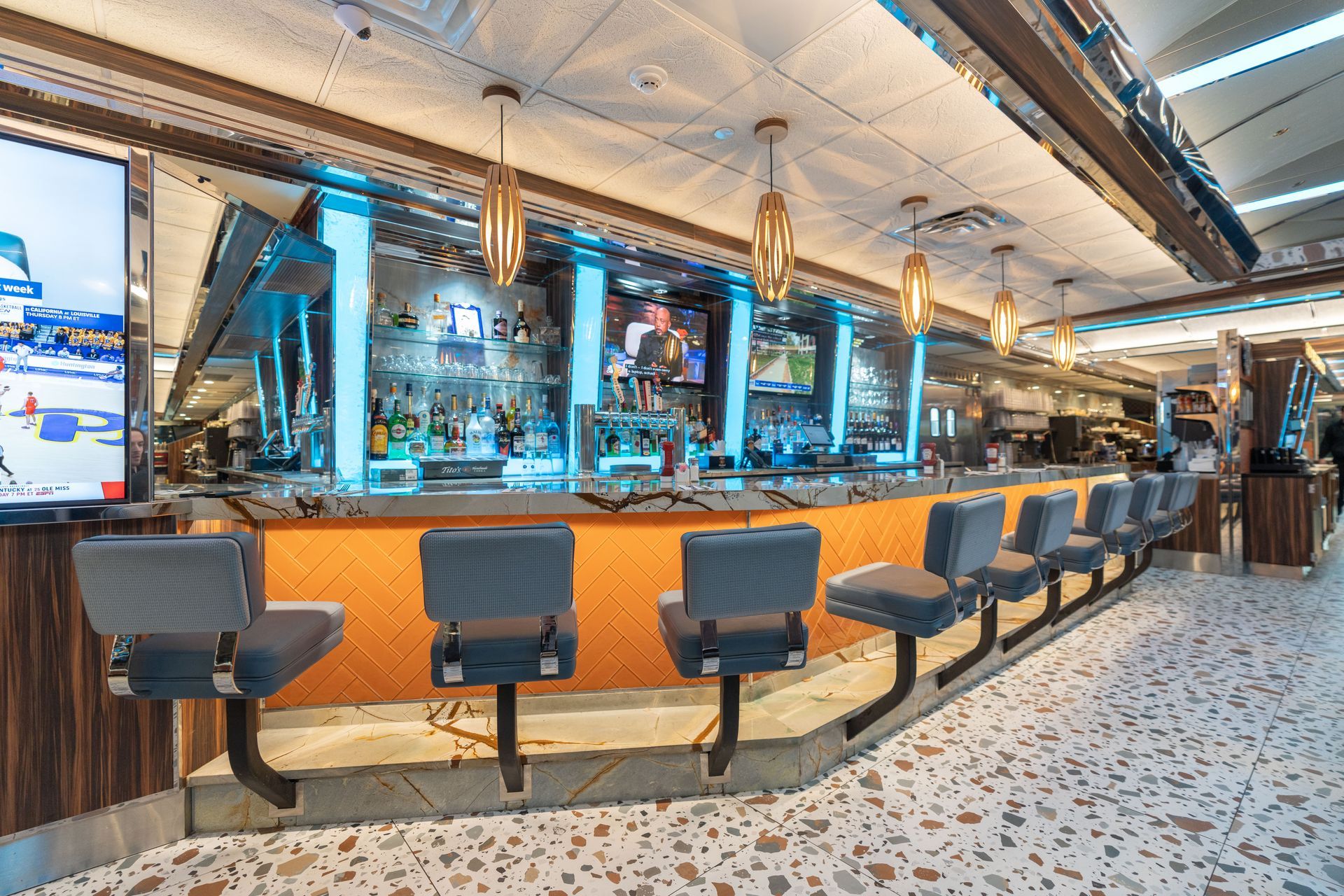 A diner with a long bar and chairs.