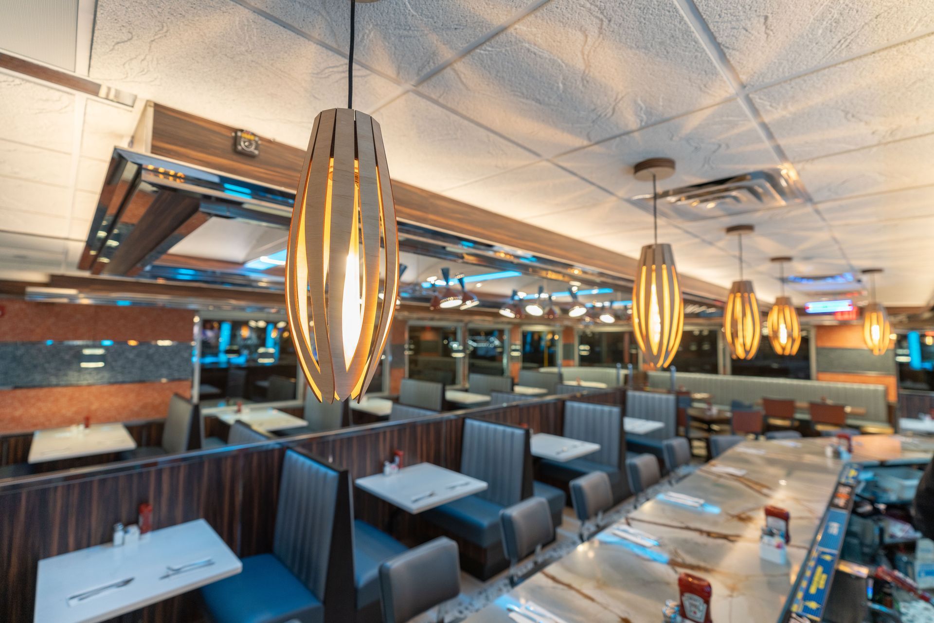 A diner with tables and chairs and a bar.