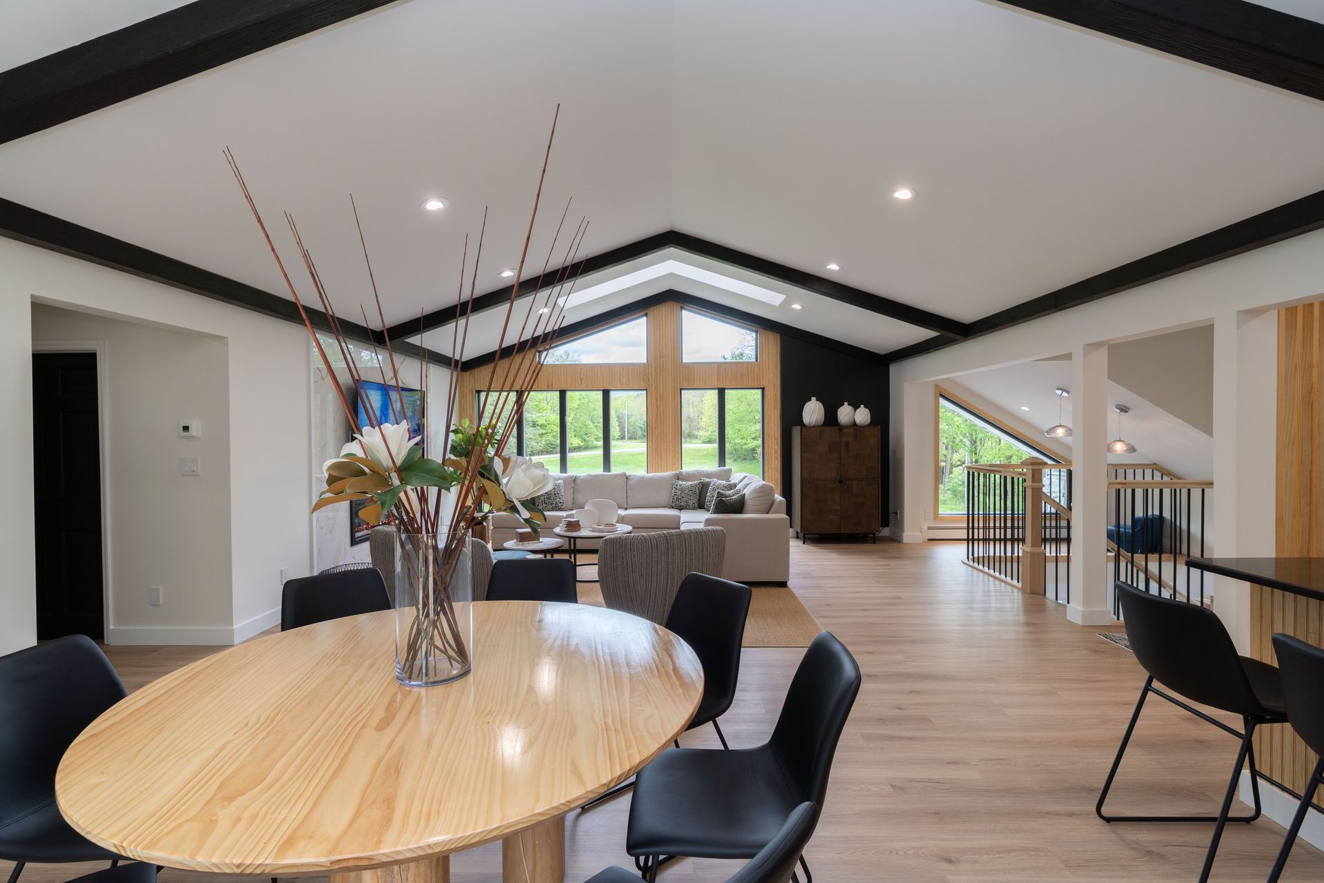 There is a table and chairs in the middle of the room.