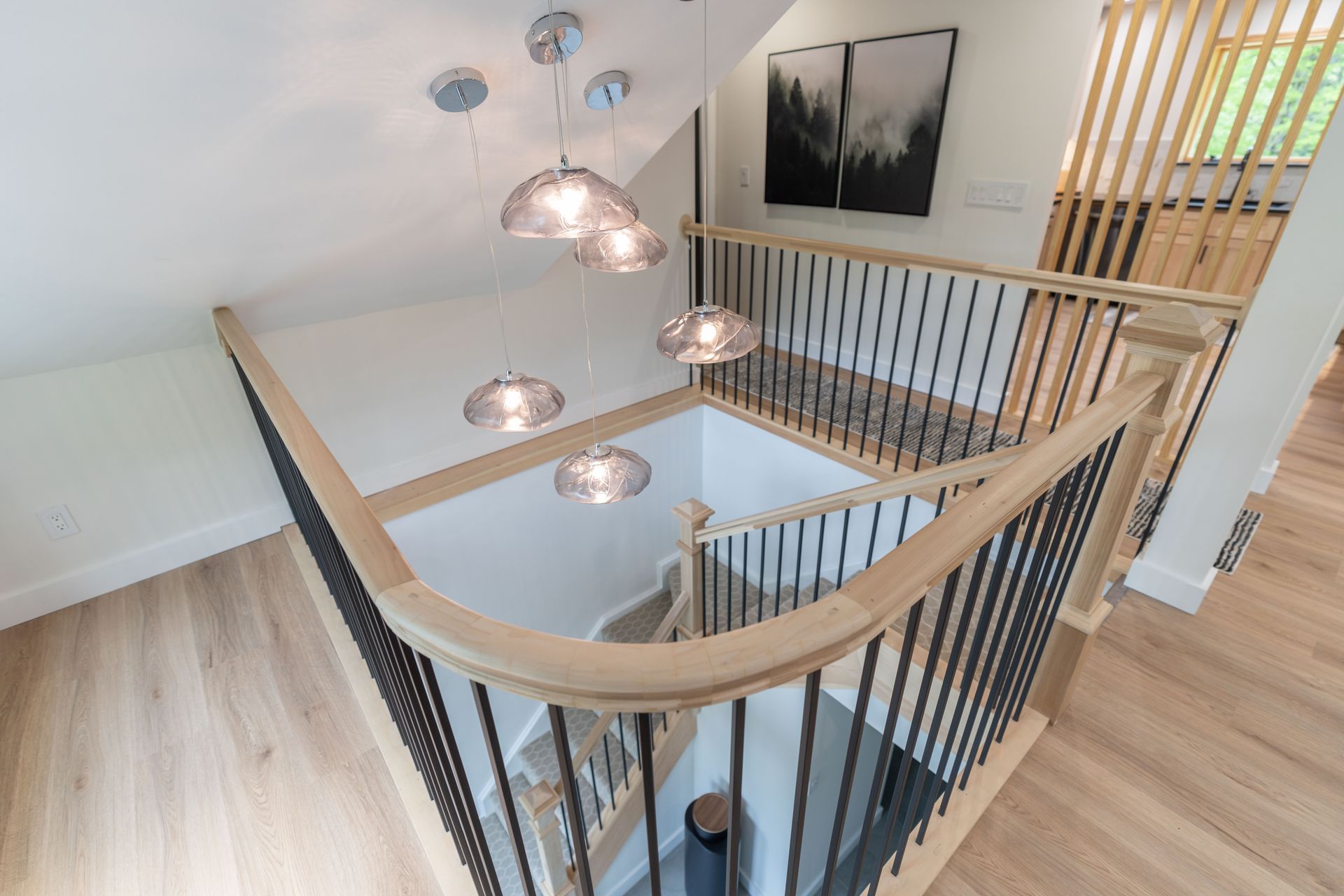 A view of a staircase from the second floor of a house.