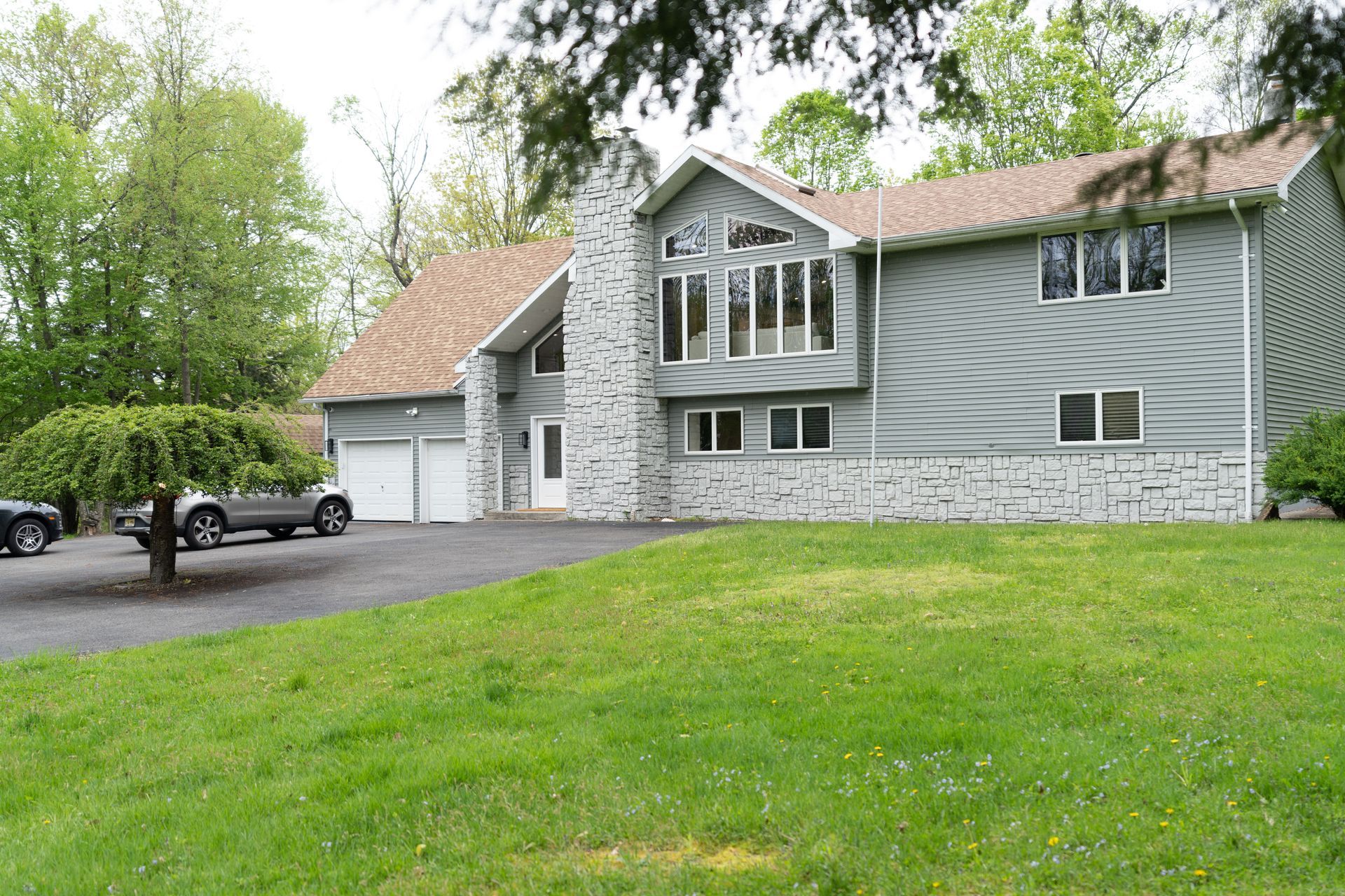 A large house with a car parked in front of it