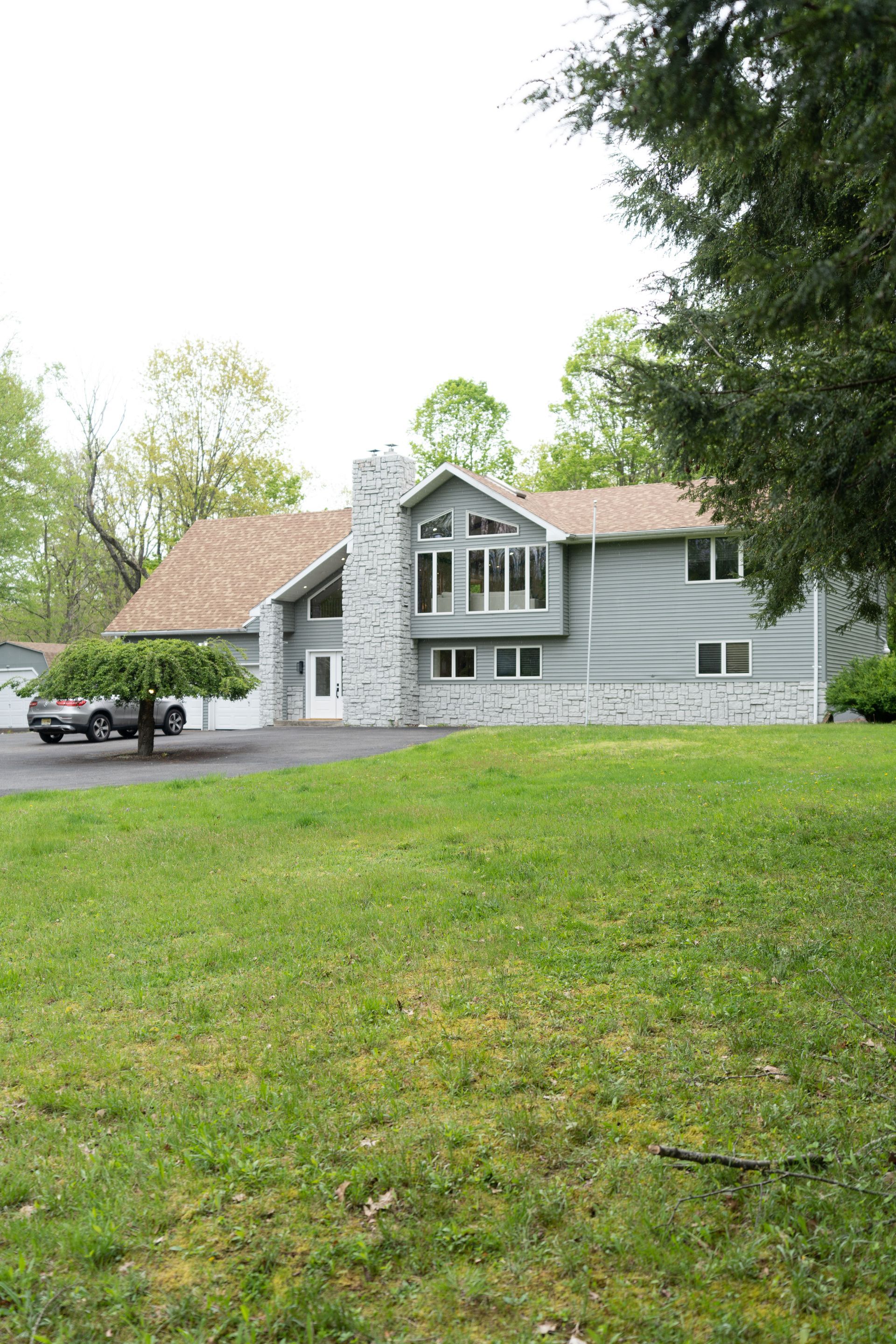 A large house with a large lawn in front of it.