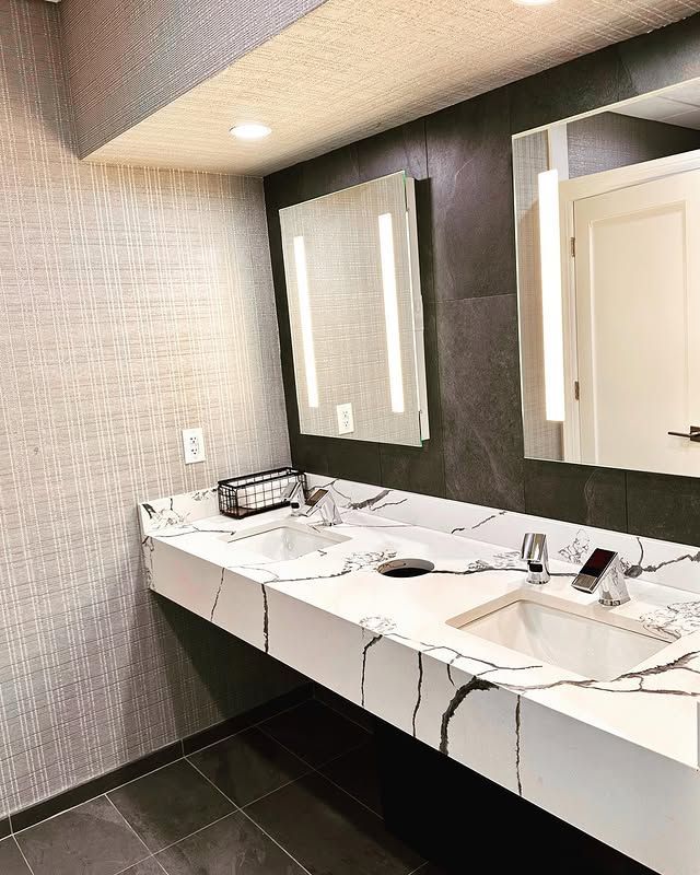 A bathroom with two sinks and two mirrors.