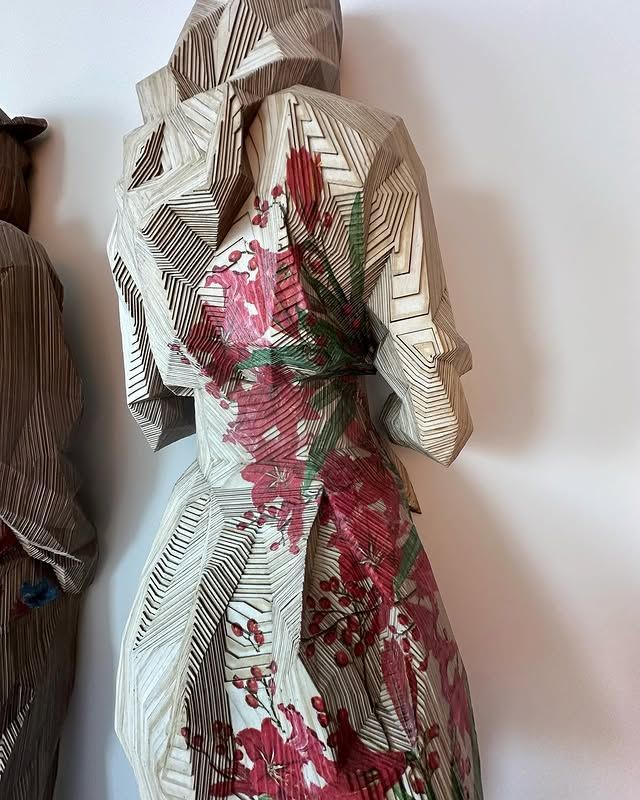 A mannequin is wearing a floral dress with a hood.