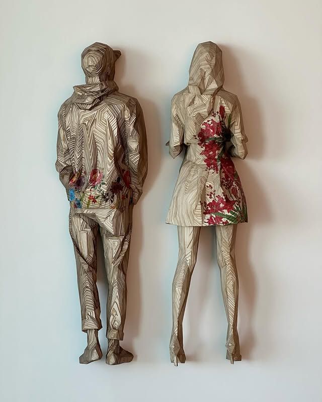 A man and a woman are standing next to each other on a wall.