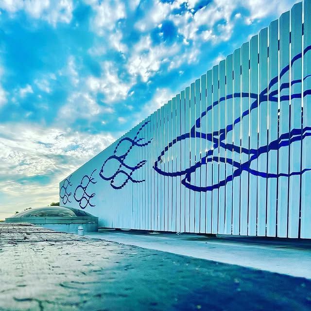 A white fence with a blue design on it