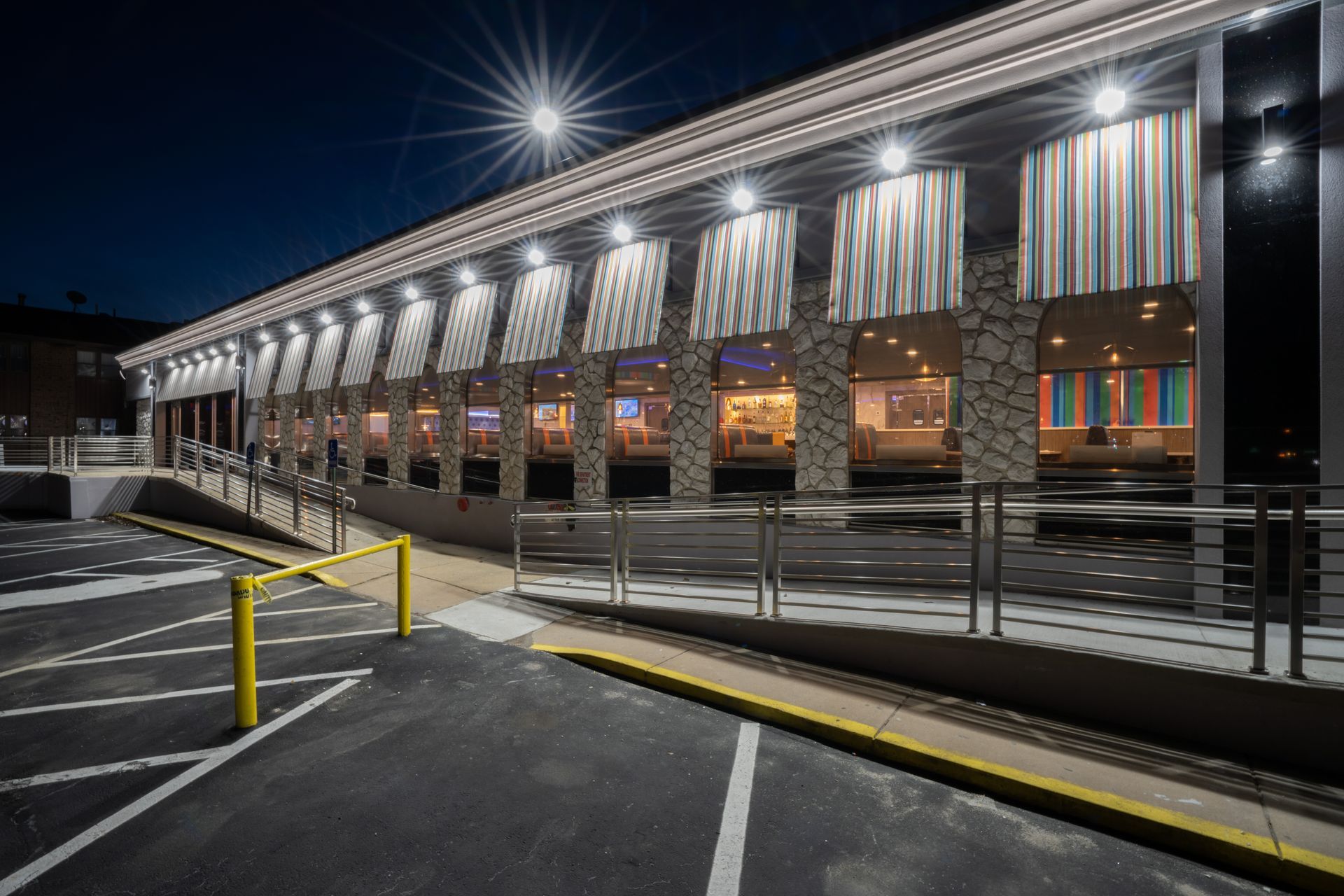 A large building with a lot of windows is lit up at night.