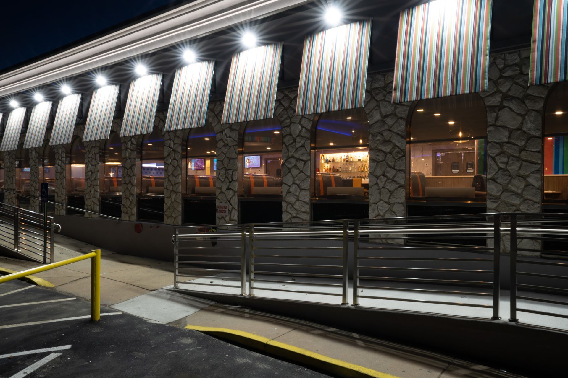 A large building with a lot of windows is lit up at night.