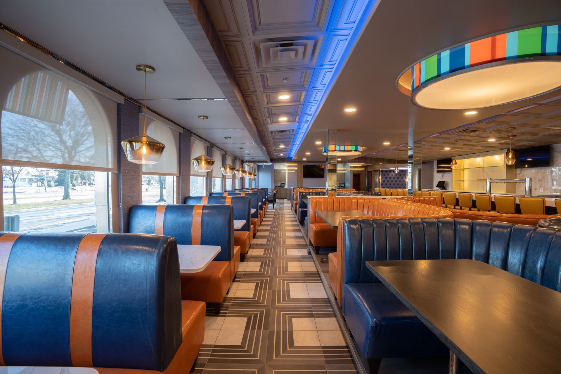 The inside of a diner with tables and booths.