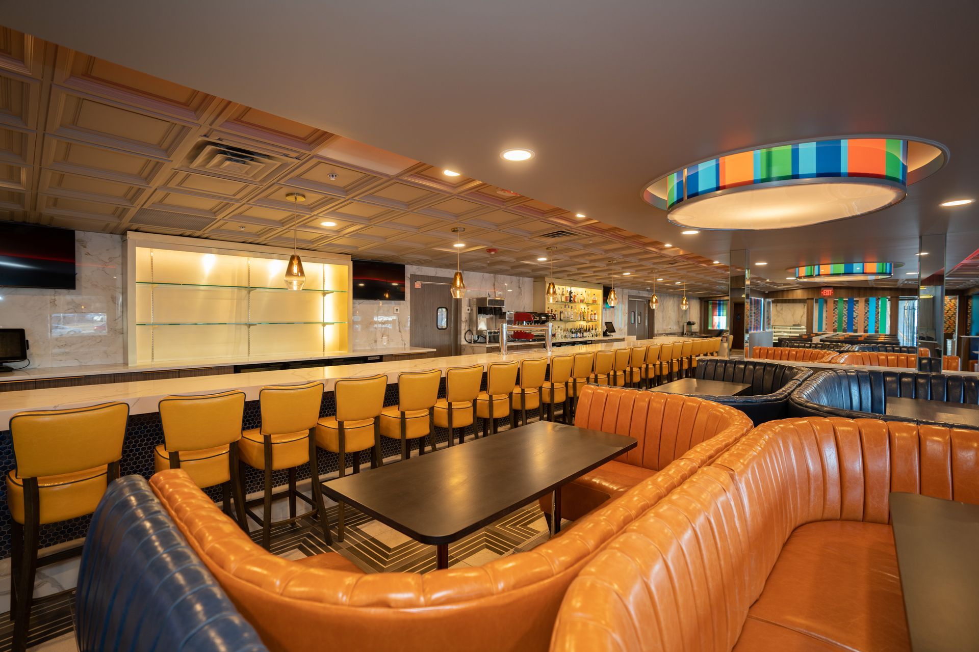 A large room with a couch , table and chairs.