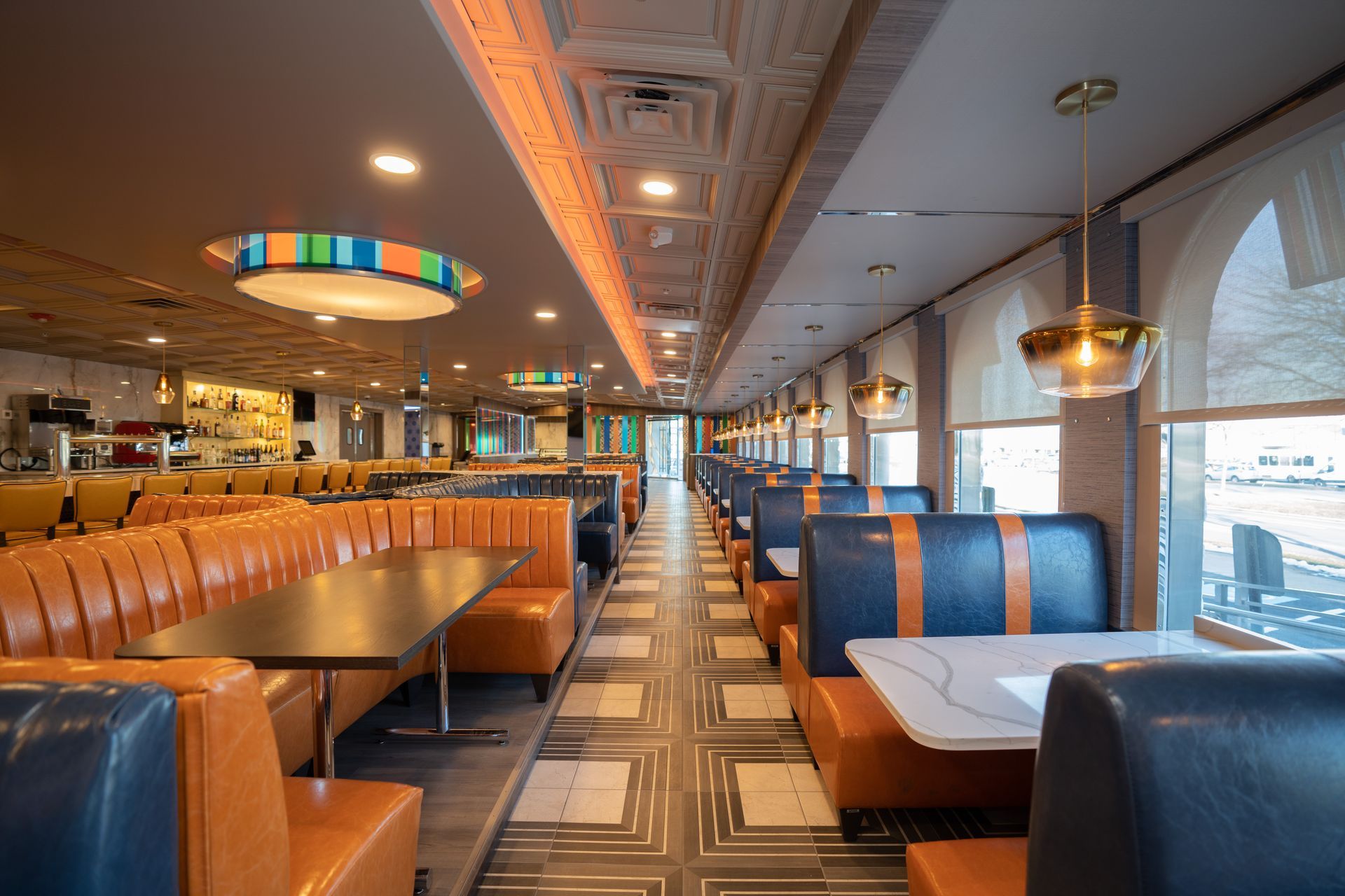 The inside of a diner with tables and booths.