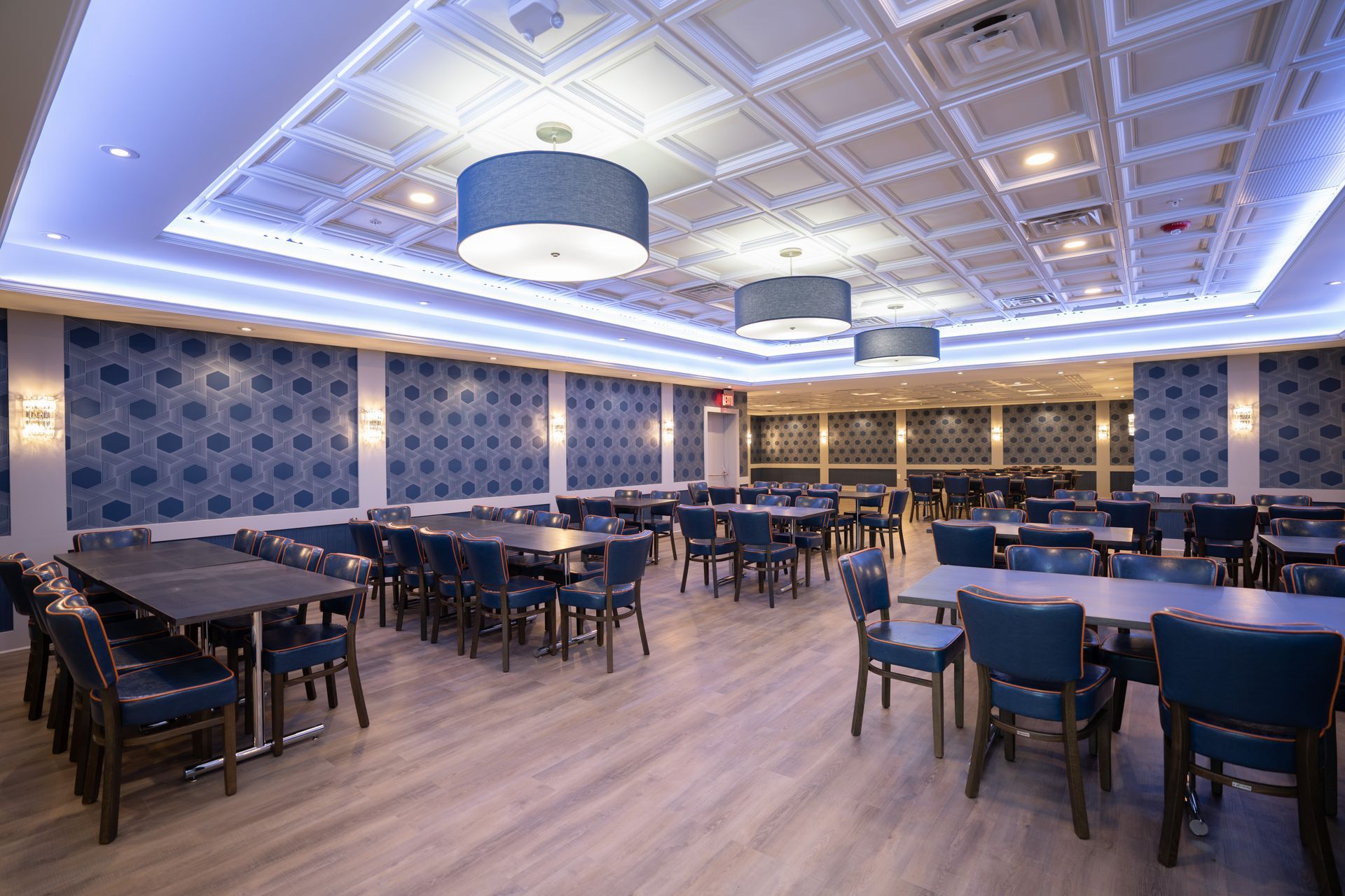 A large room filled with tables and chairs in a restaurant.