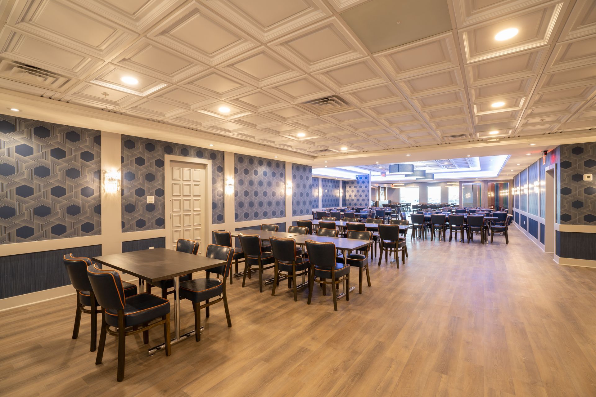 A large room with tables and chairs in it.