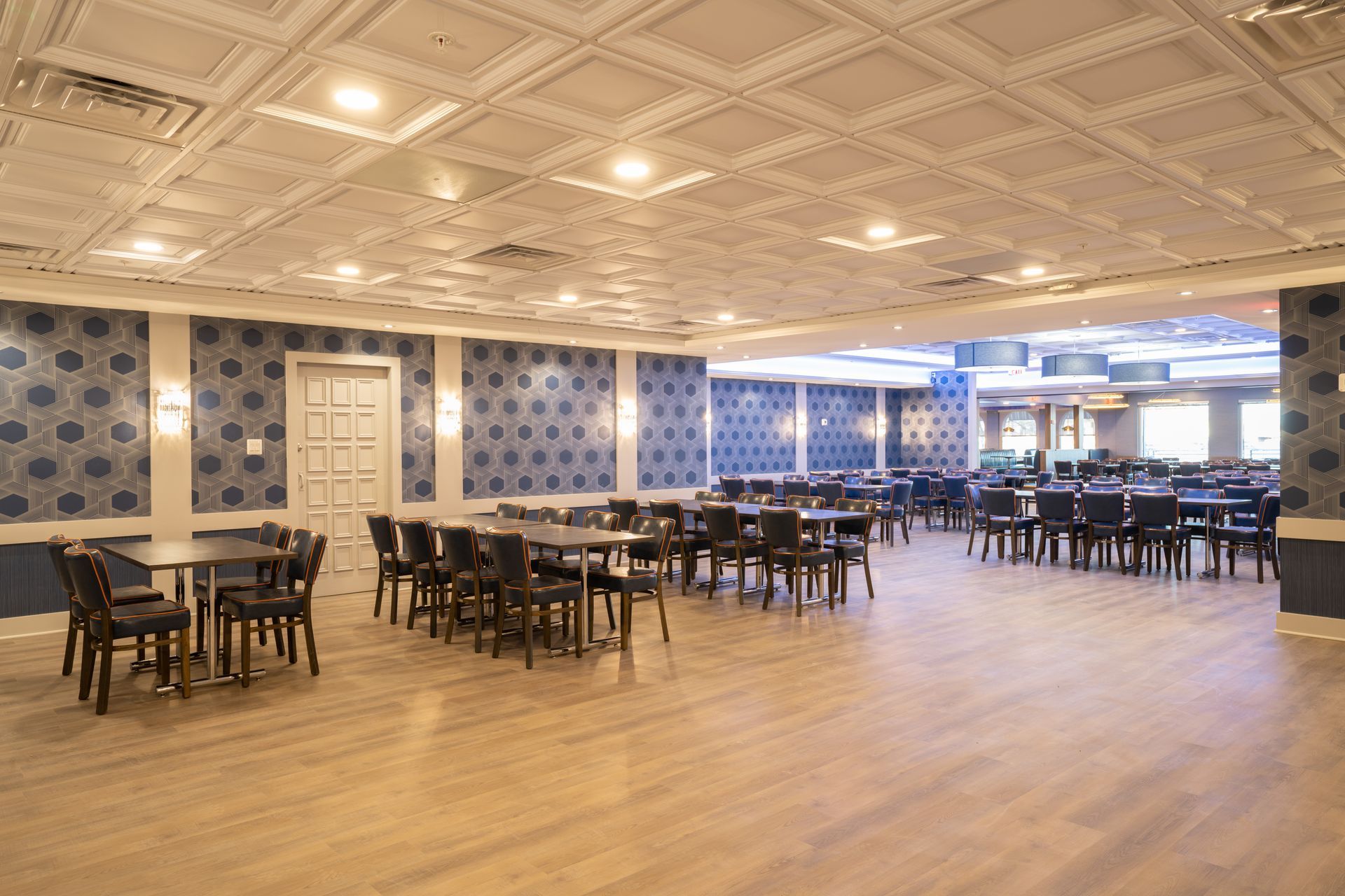 A large room with tables and chairs in it.