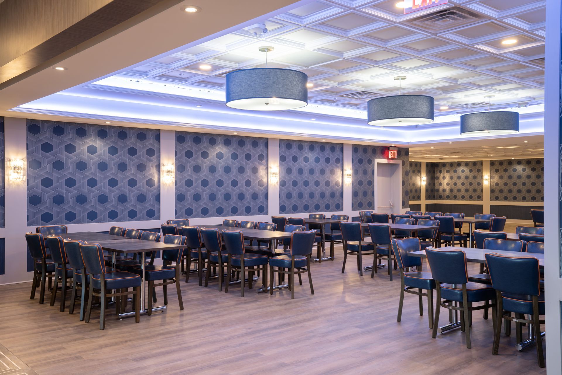 A large room filled with tables and chairs in a restaurant.