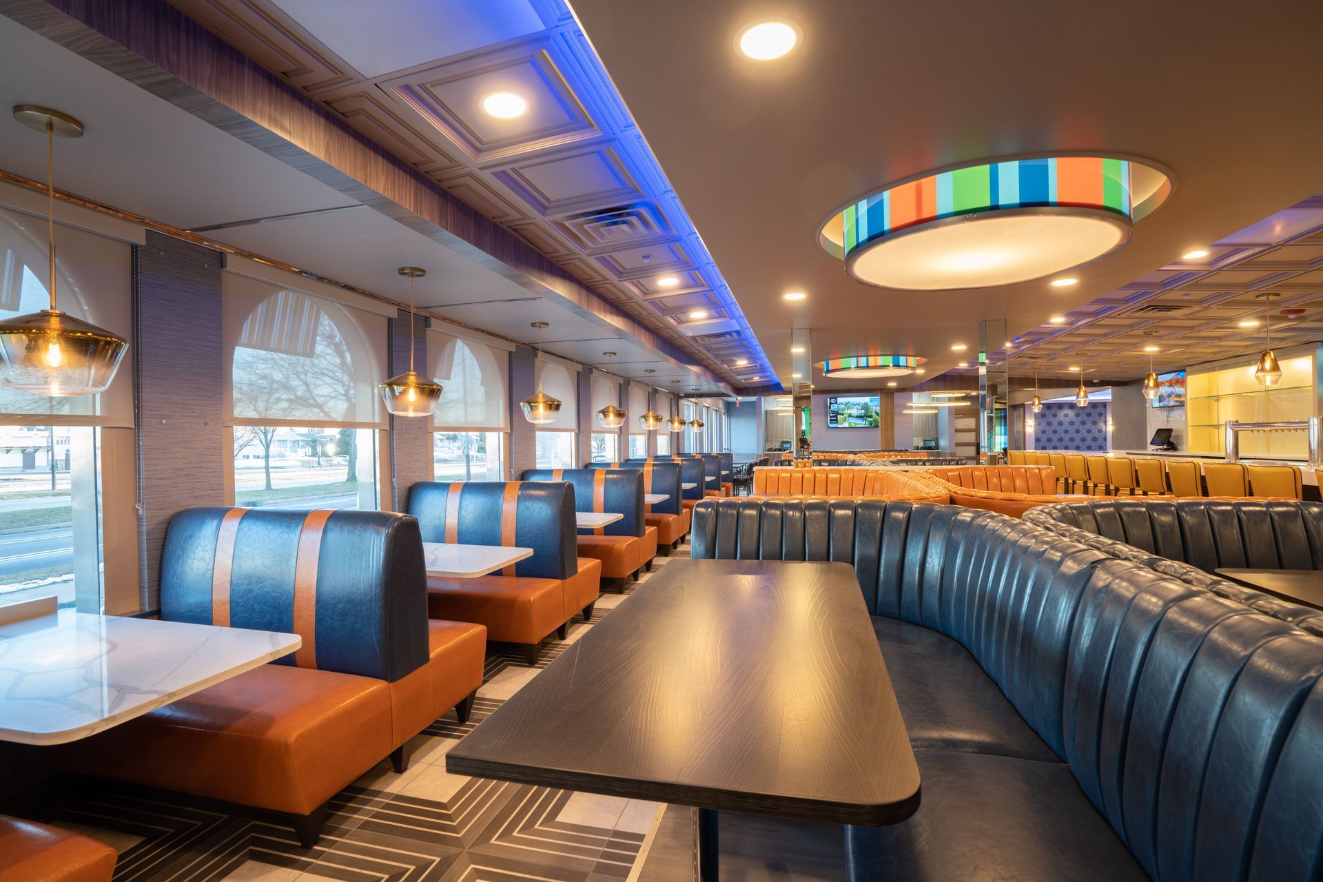 A diner with tables and booths and a ceiling light.