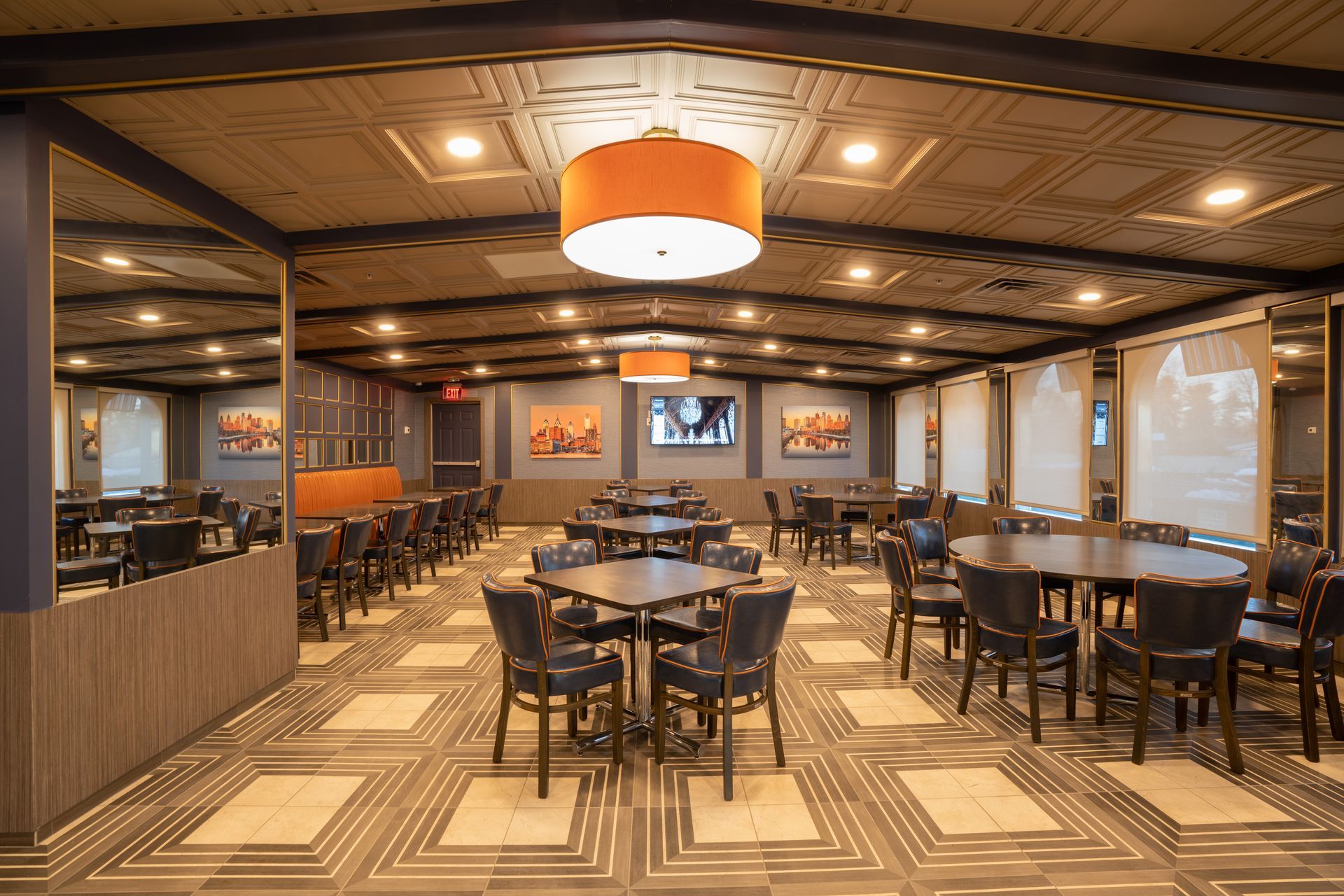 A large room filled with tables and chairs in a restaurant.