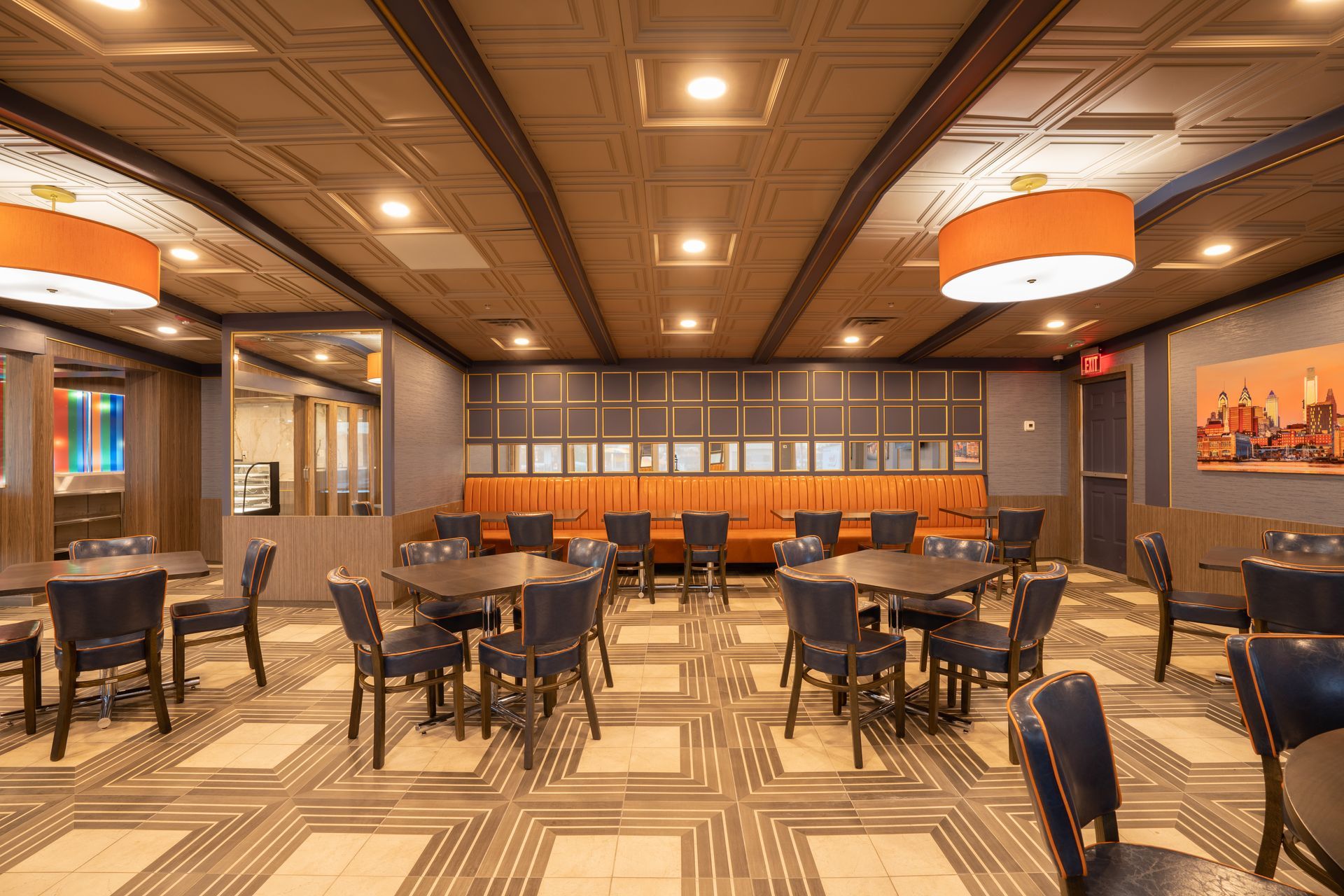 A large dining room with tables and chairs and a couch.