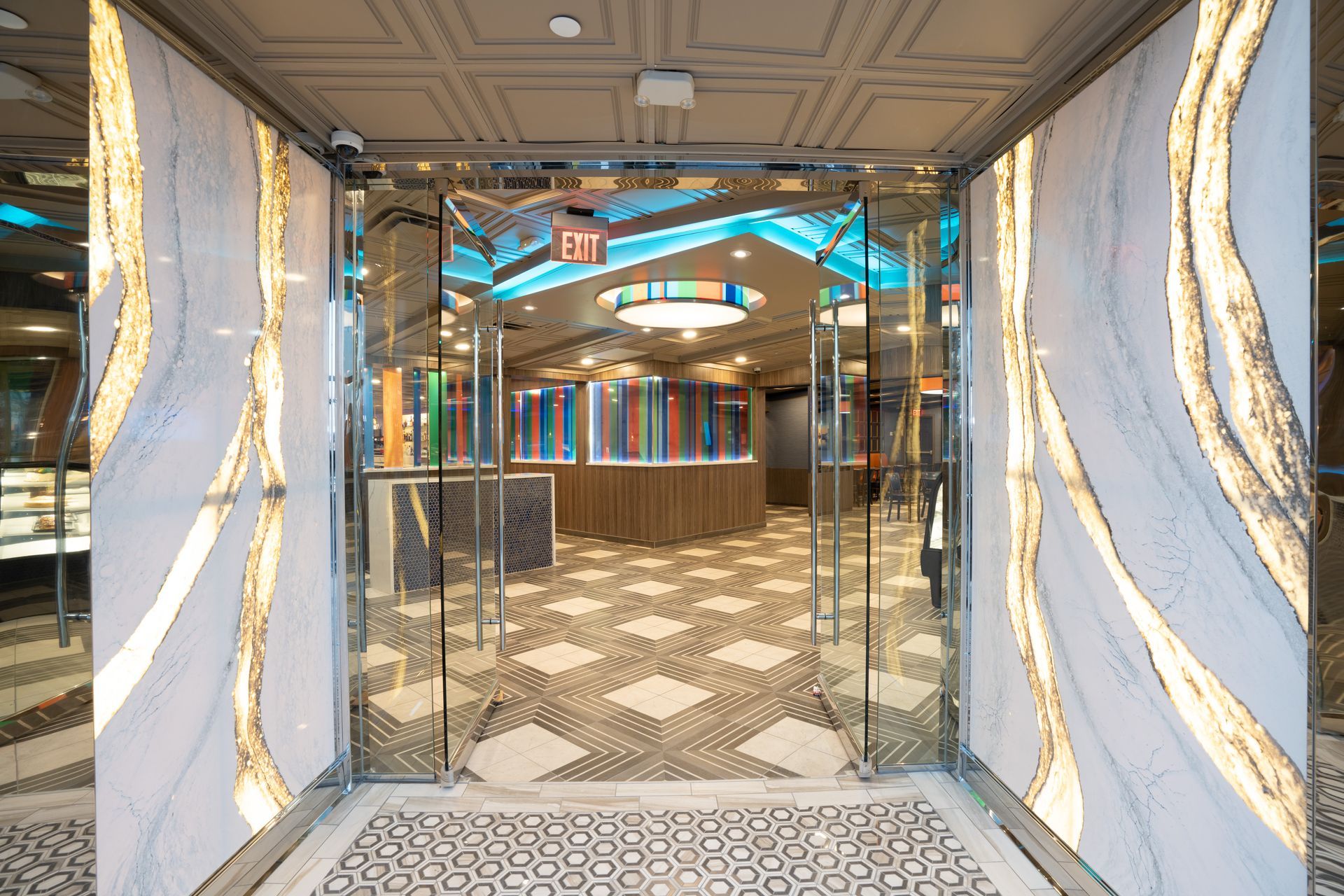 A large hallway with a glass door and a sign that says exit.