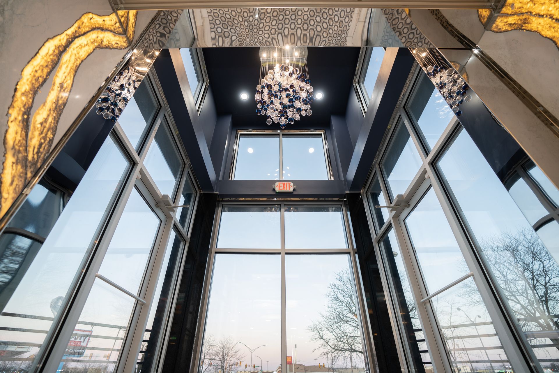 A large building with a lot of windows and a chandelier hanging from the ceiling.