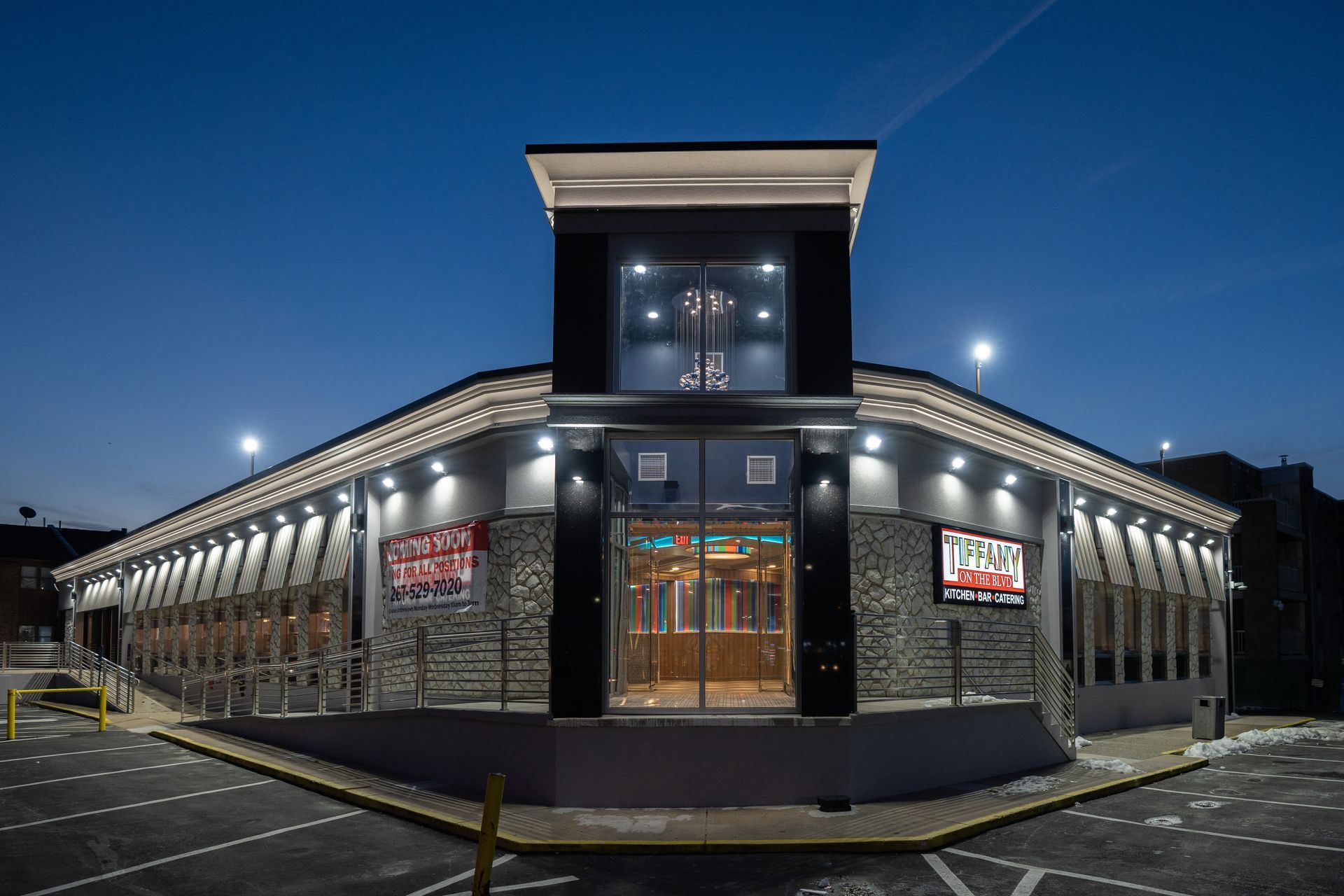 A large building with a lot of windows is lit up at night.