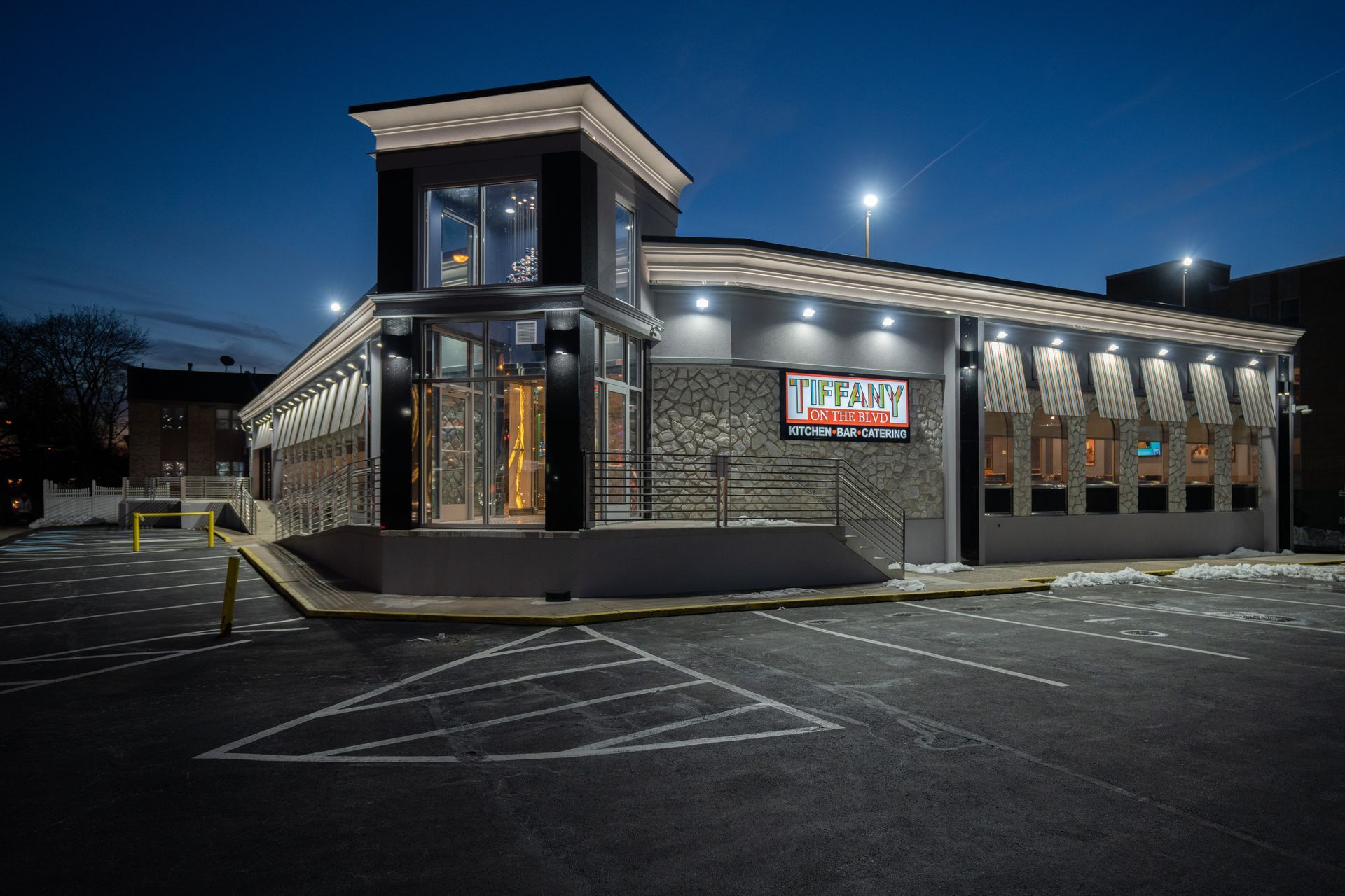 A large building with a lot of windows is lit up at night.