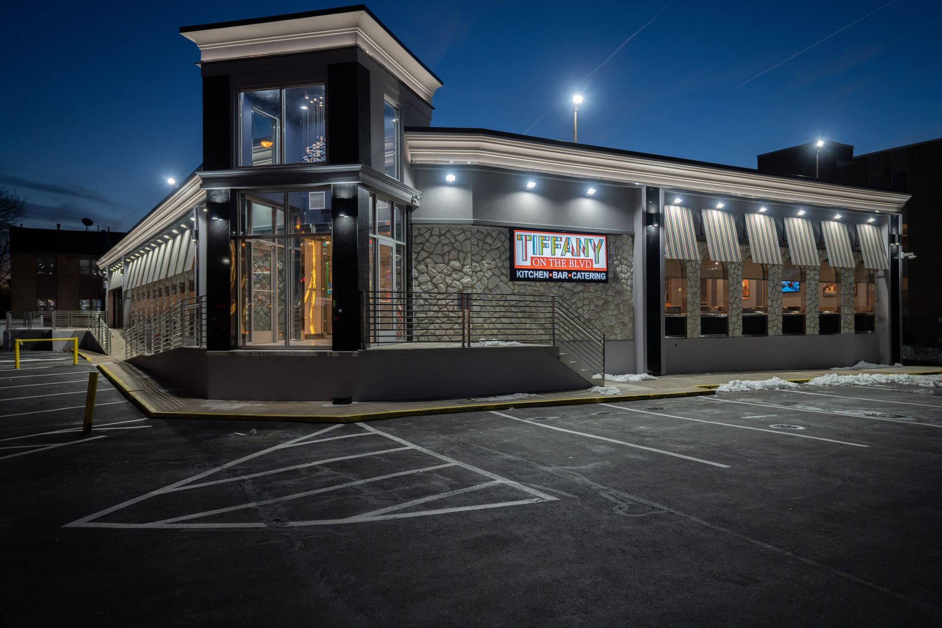 A large building with a lot of windows is lit up at night.