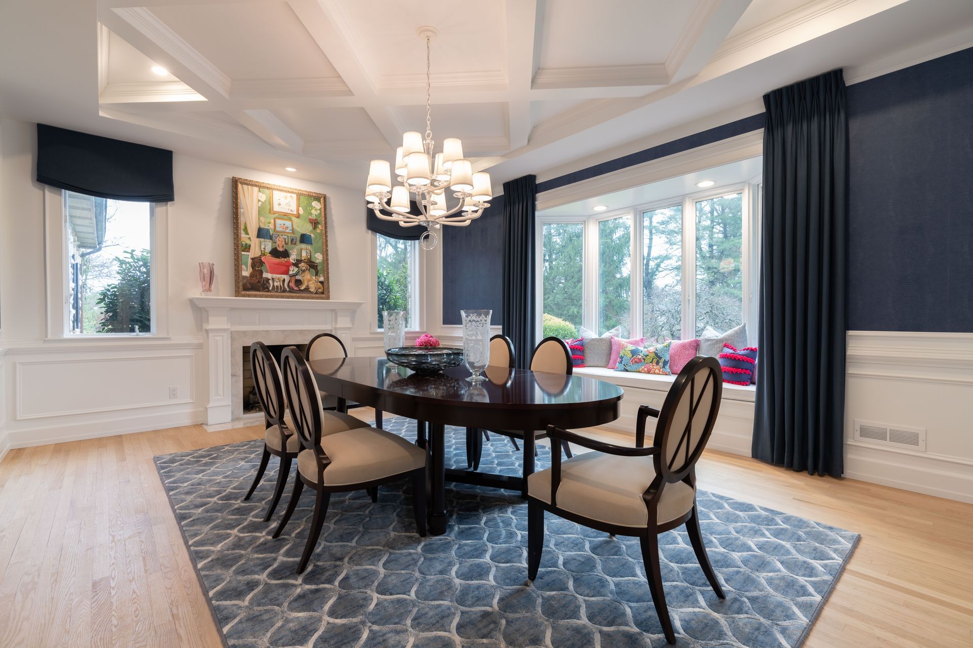 A dining room with a table and chairs and a chandelier.