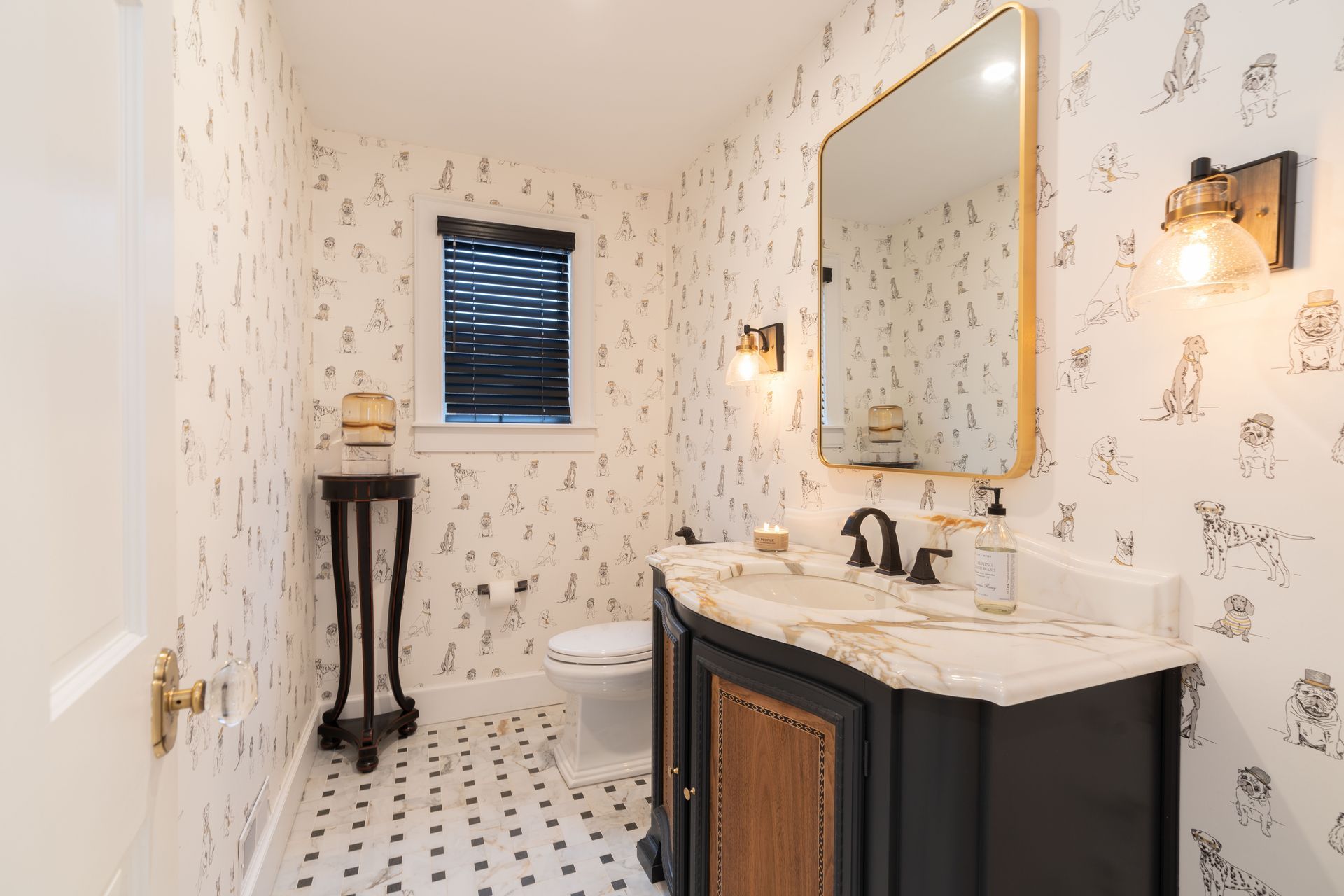 A bathroom with a sink , toilet and mirror.