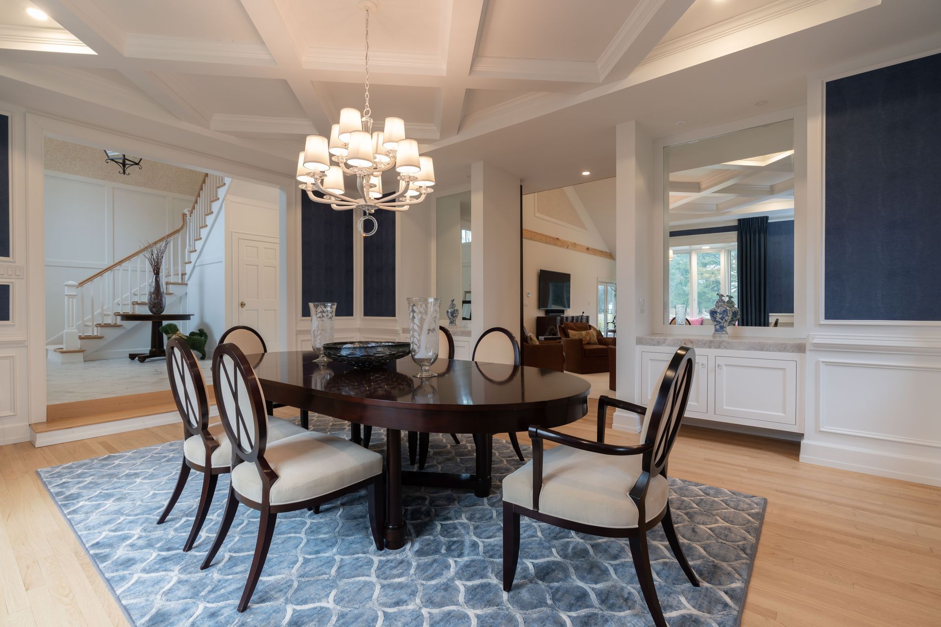 A dining room with a table and chairs and a chandelier.