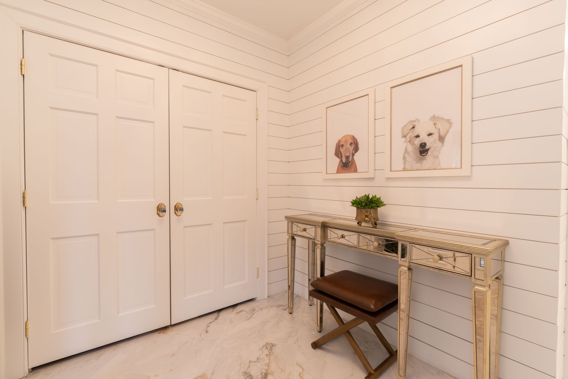 A room with white walls and a desk and a bench.