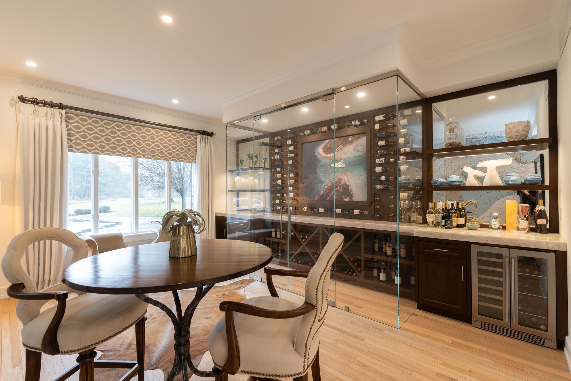 A dining room with a table and chairs and a wine cellar.