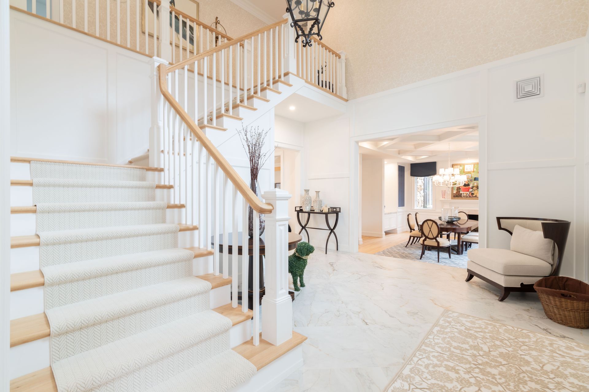 There is a staircase in the middle of the room leading up to the second floor.