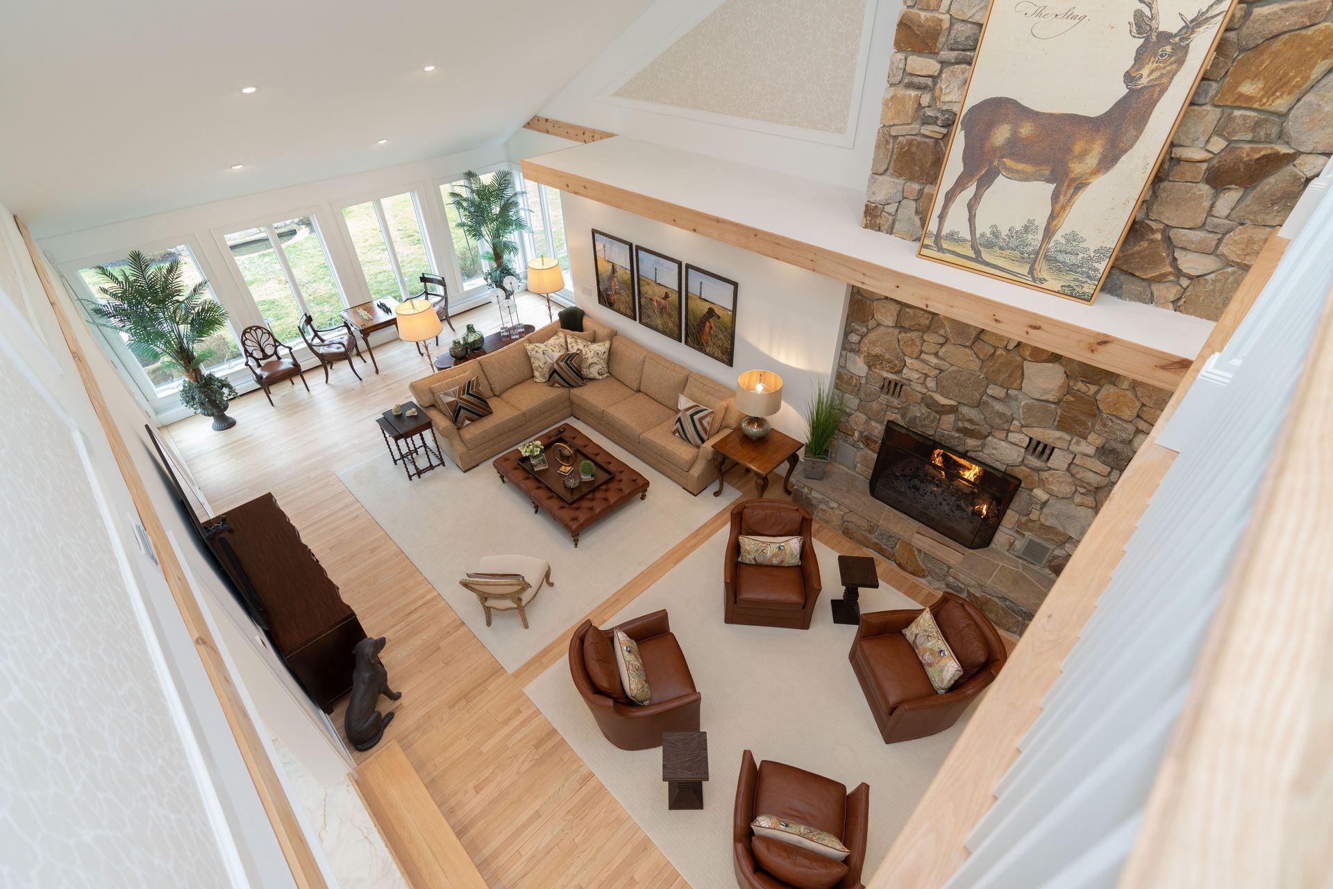 An aerial view of a living room with furniture and a fireplace.