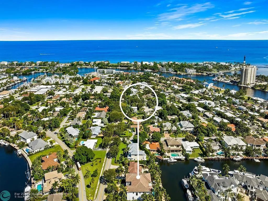 An aerial view of a residential area with a house in the middle of it.